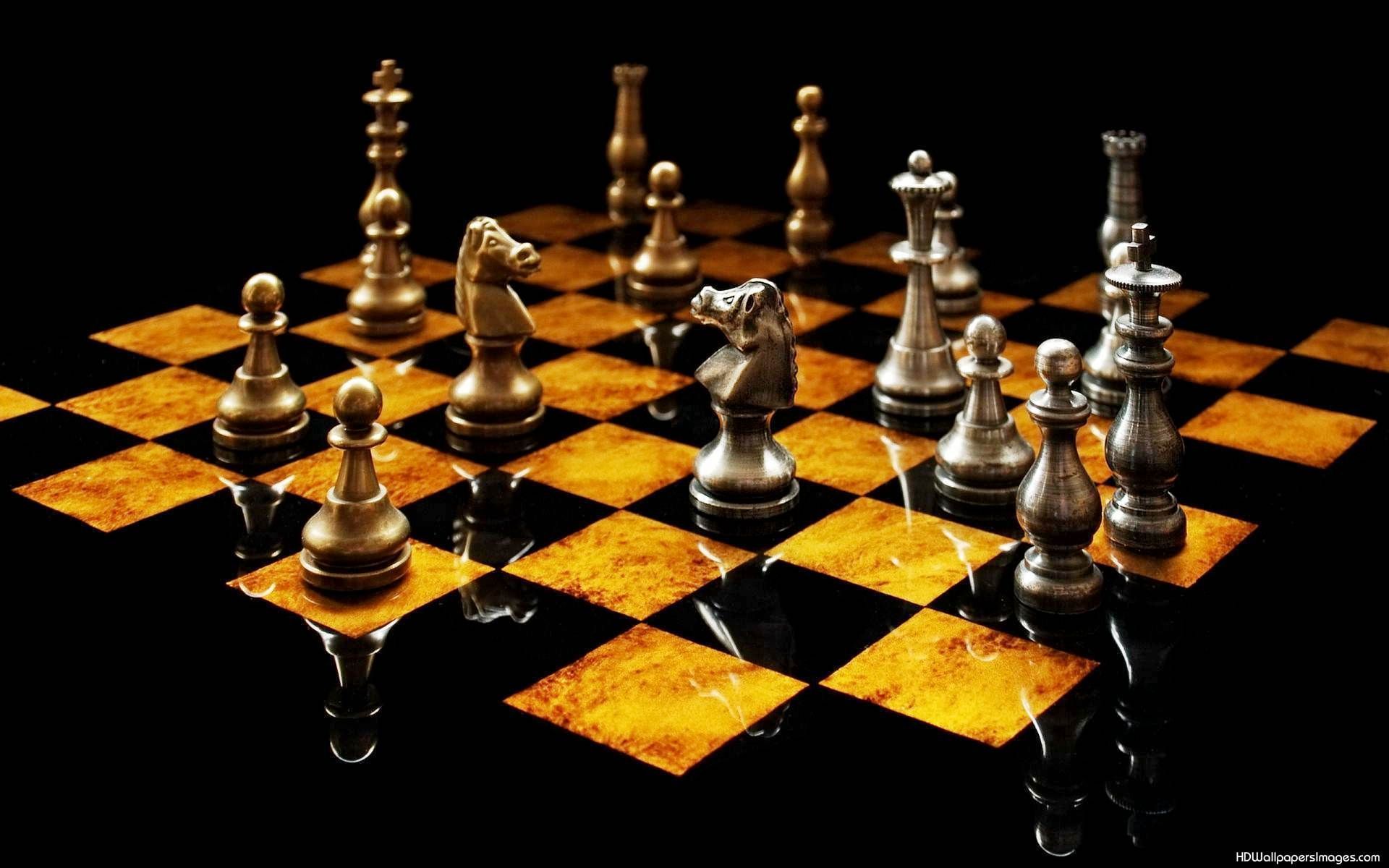 A chess board with silver and gold chess pieces on a black background. The pieces are lined up in a row on the board. The image is in high resolution and can be used for wallpaper or other purposes. - Chess