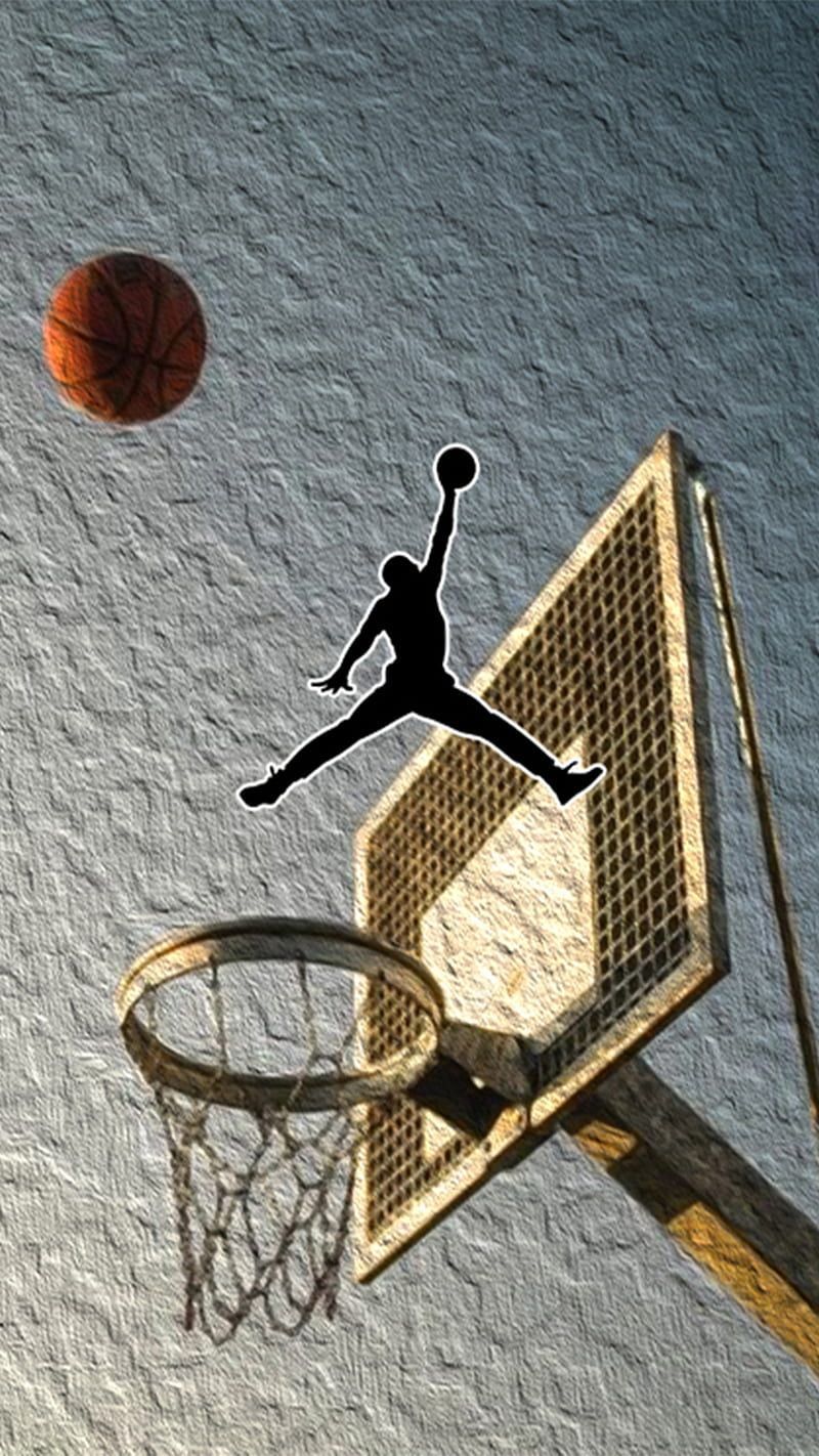 A silhouette of a basketball player jumping to make a basket - Michael Jordan