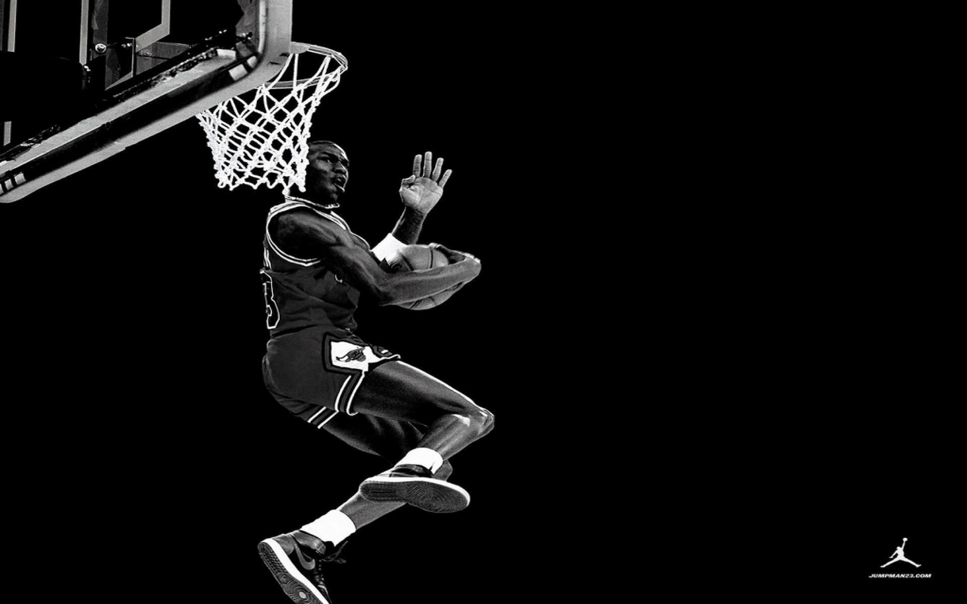 A black and white wallpaper of Michael Jordan scoring a basket. - Michael Jordan