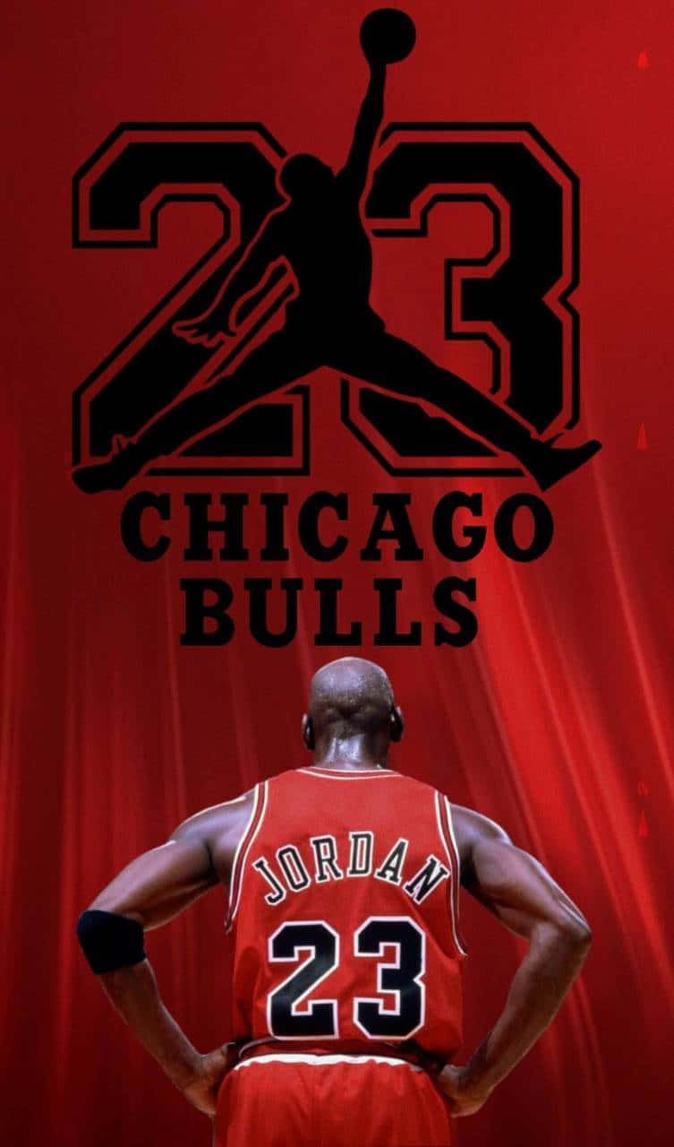 Michael Jordan standing in front of a red curtain with the number 23 in black and the words Chicago Bulls in black. - Michael Jordan