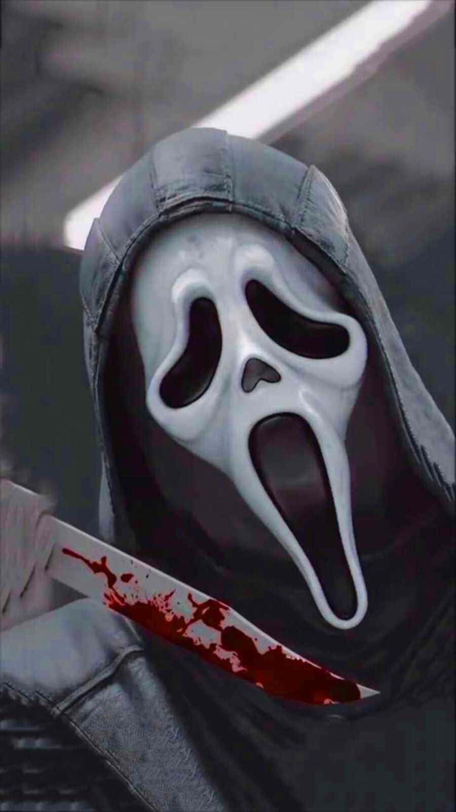 A man wearing a scream mask and holding a knife. - Ghostface