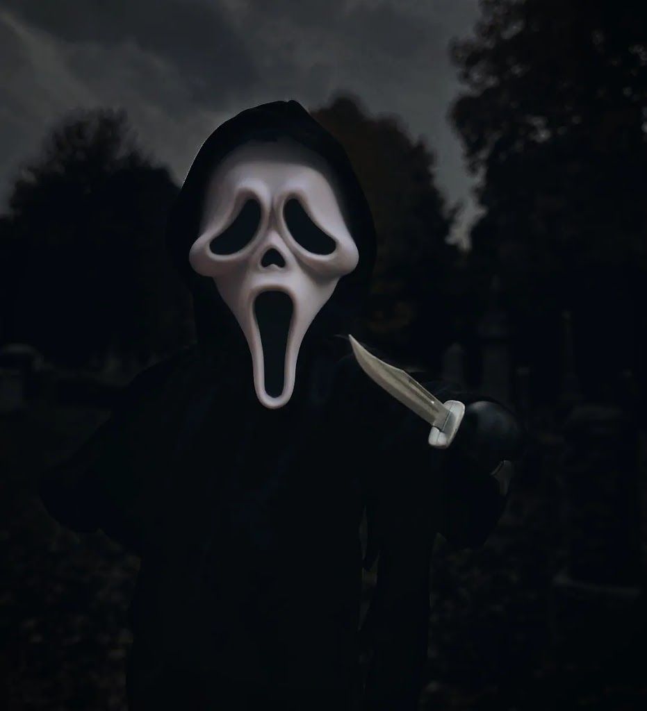 A ghostface killer from the movie Scream holding a knife. - Ghostface