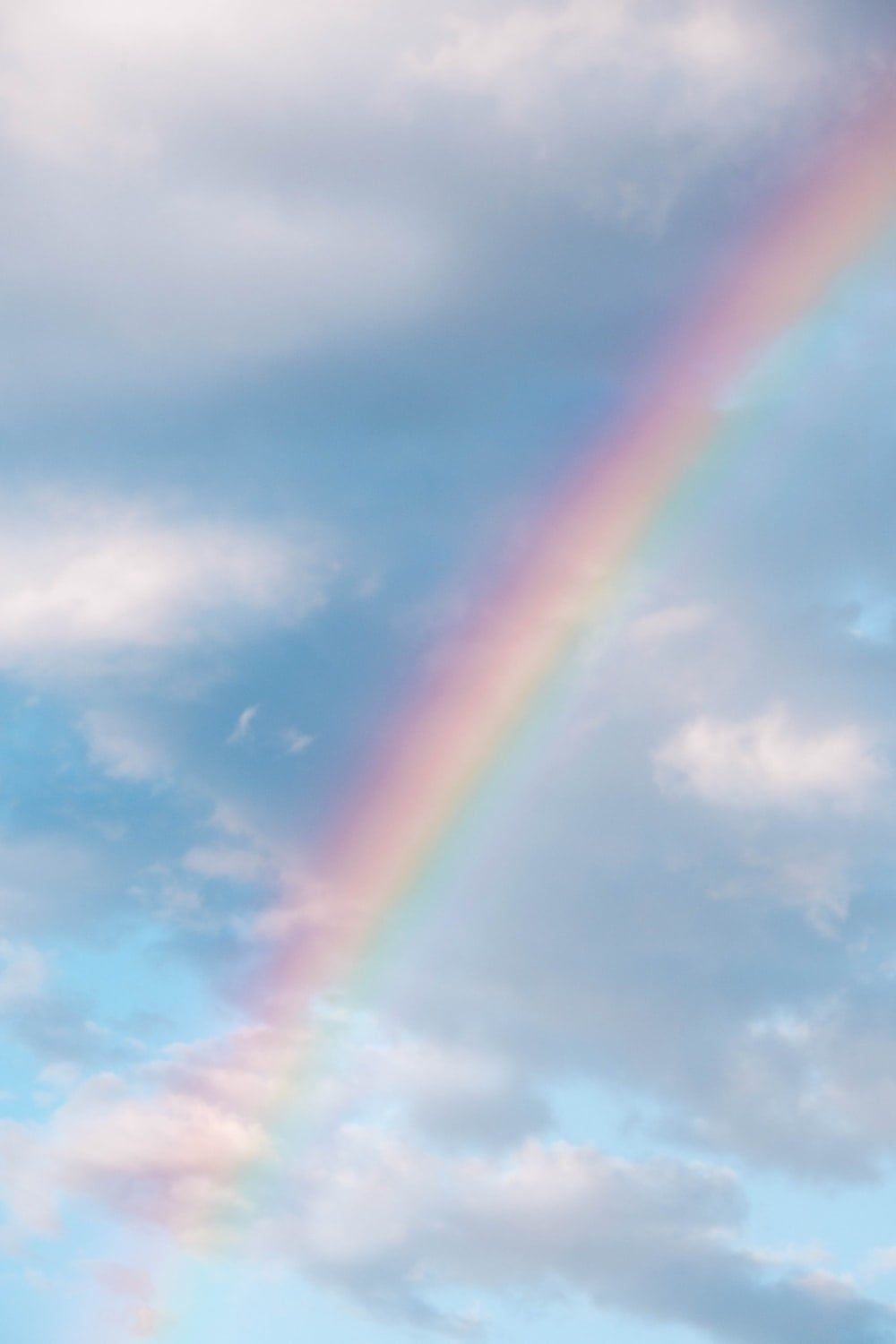 A beautiful rainbow in the sky with clouds - Pastel rainbow