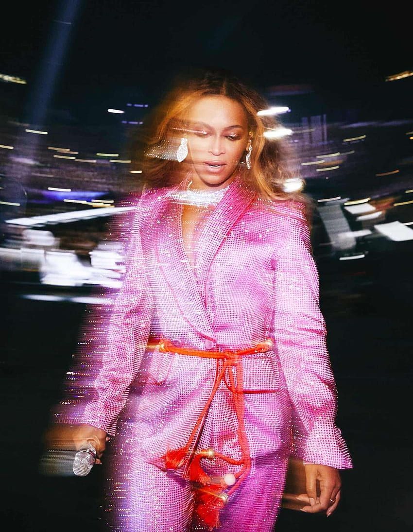 Beyoncé in a pink suit walking down a street - Beyonce