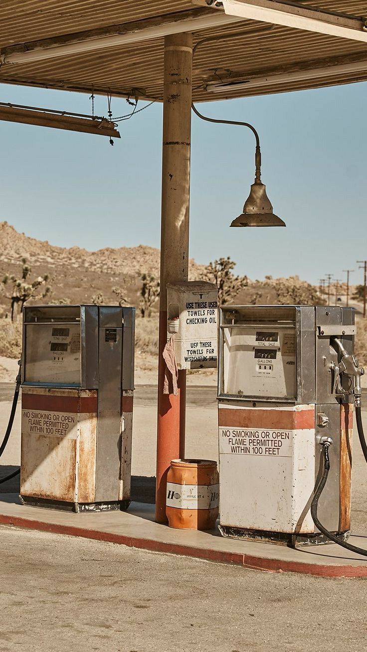A gas station with two pumps and one car - Vintage