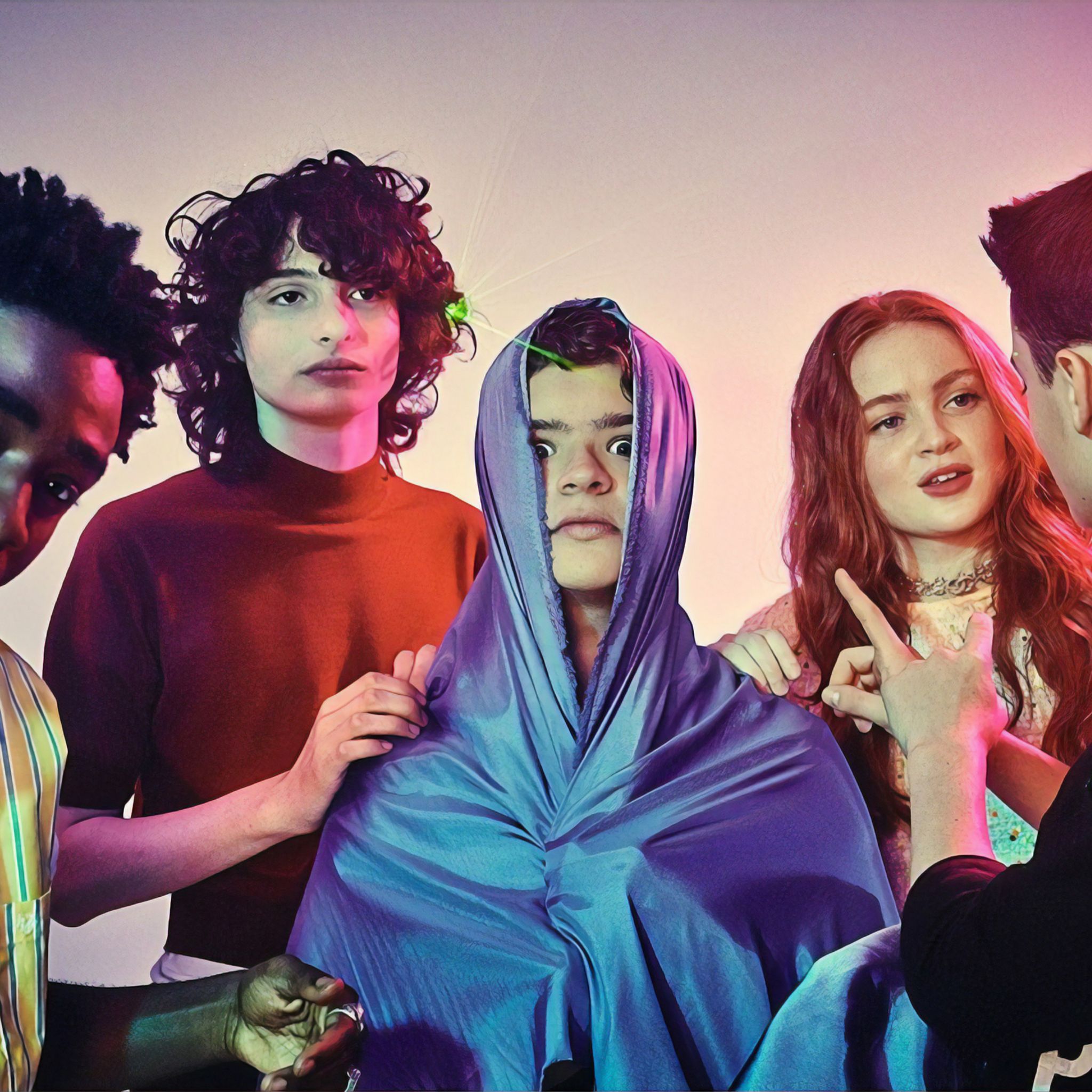 The cast of 'Stranger Things' season 3, including Millie Bobby Brown, Finn Wolfhard, and Gaten Matarazzo, in a promotional image. - Stranger Things