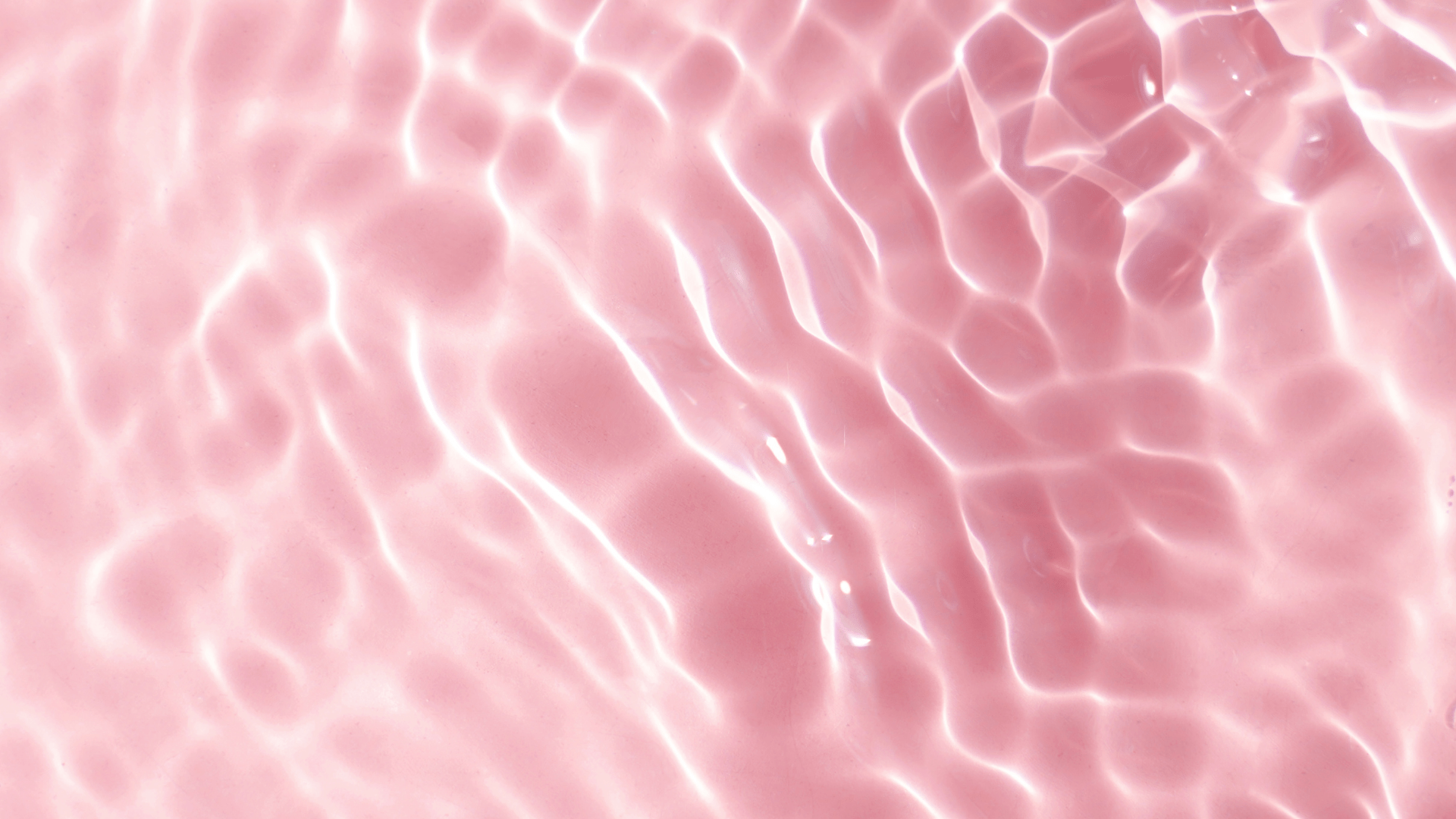 A close-up of water on a pink background. - Blush