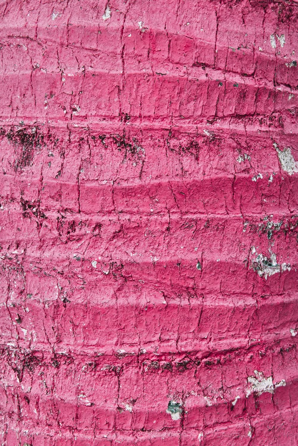 A pink brick wall with peeling paint - Blush