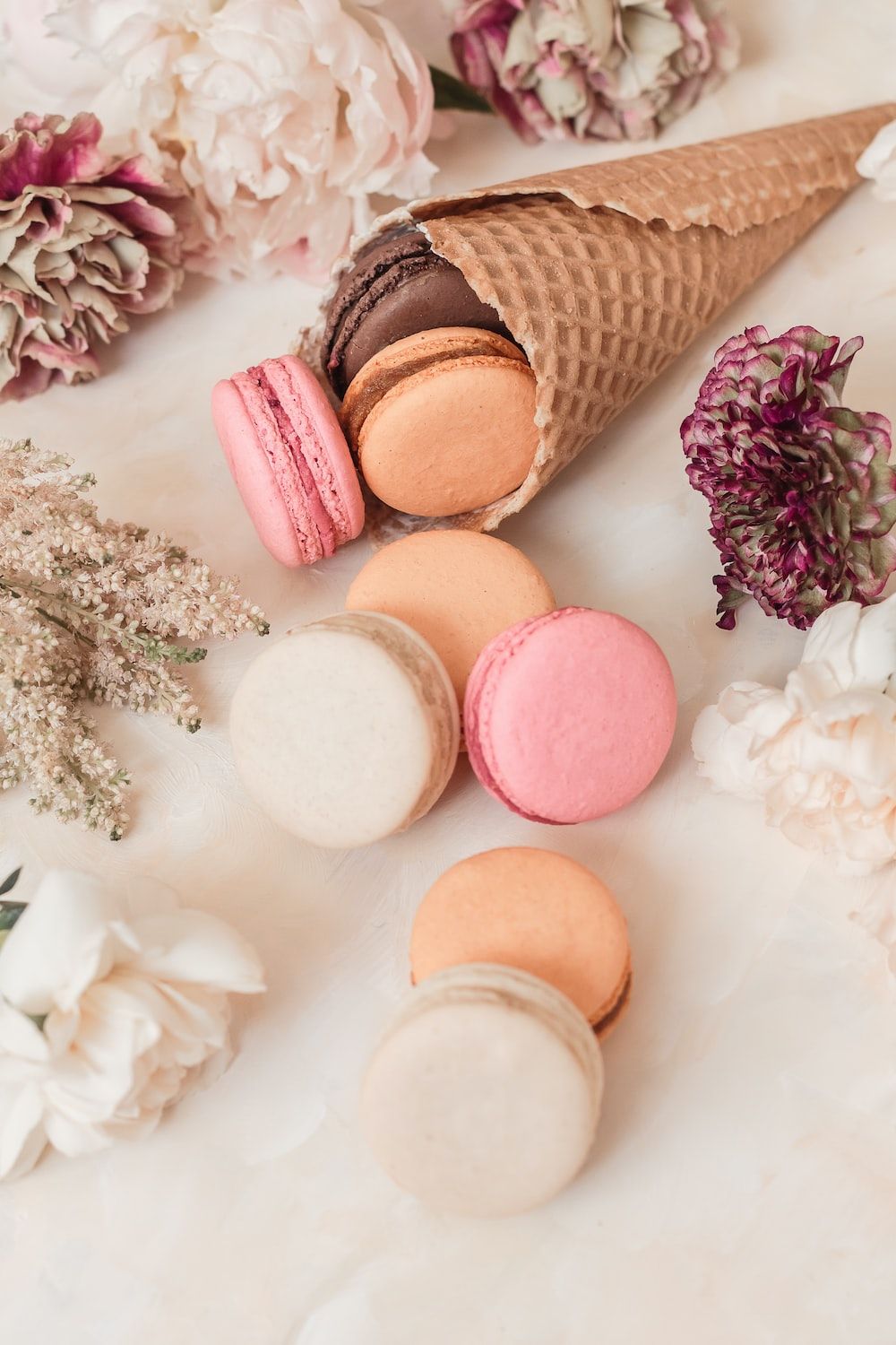 Pink and white macaroons on white table photo