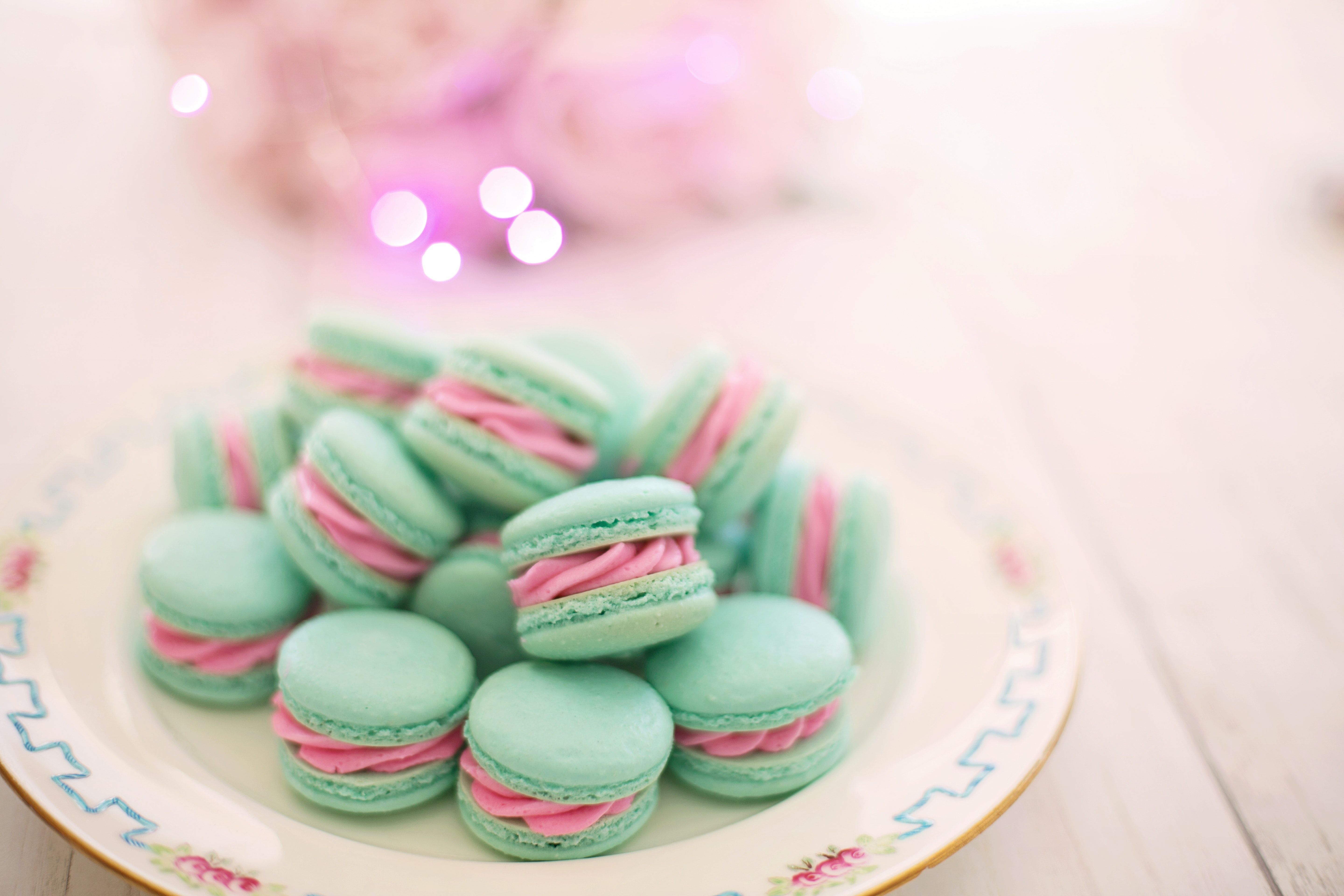 A plate of blue and pink macarons - Macarons