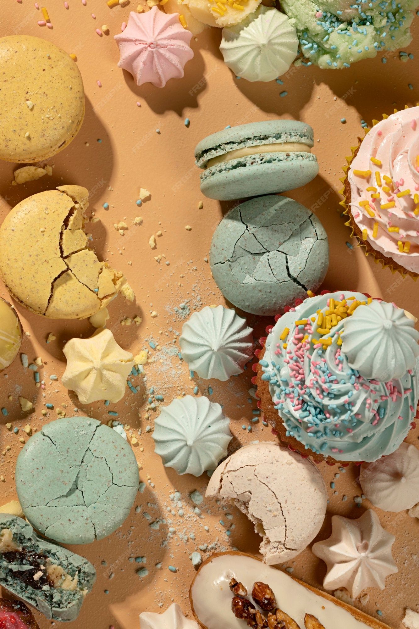 A variety of different colored pastries on a tan background - Macarons