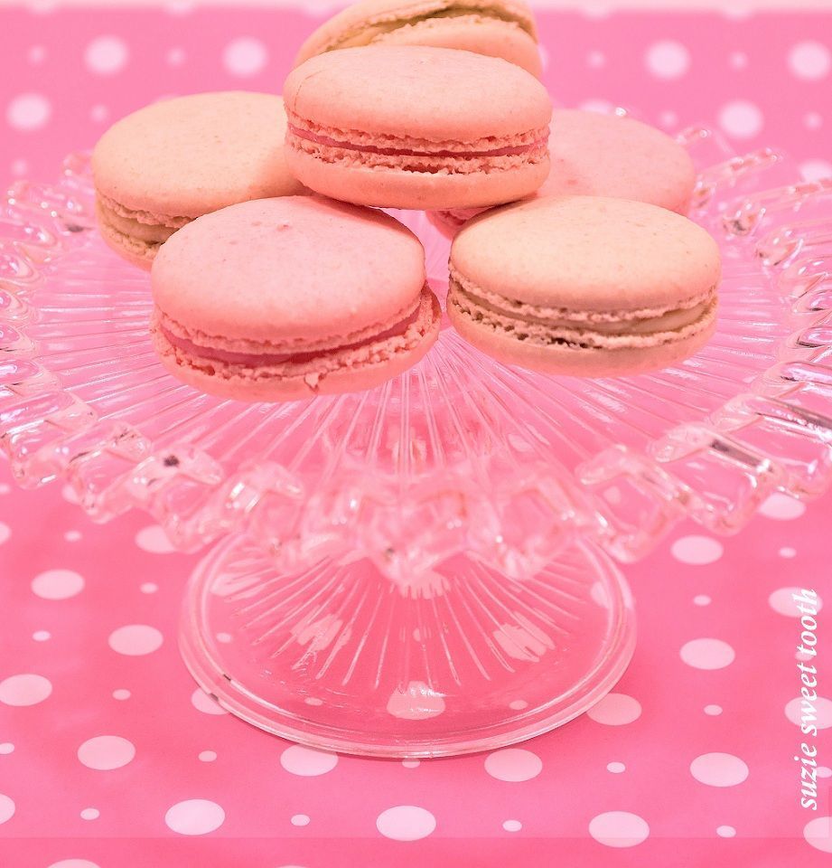 Pink macarons on a pink and white polka dot cake stand. - Macarons