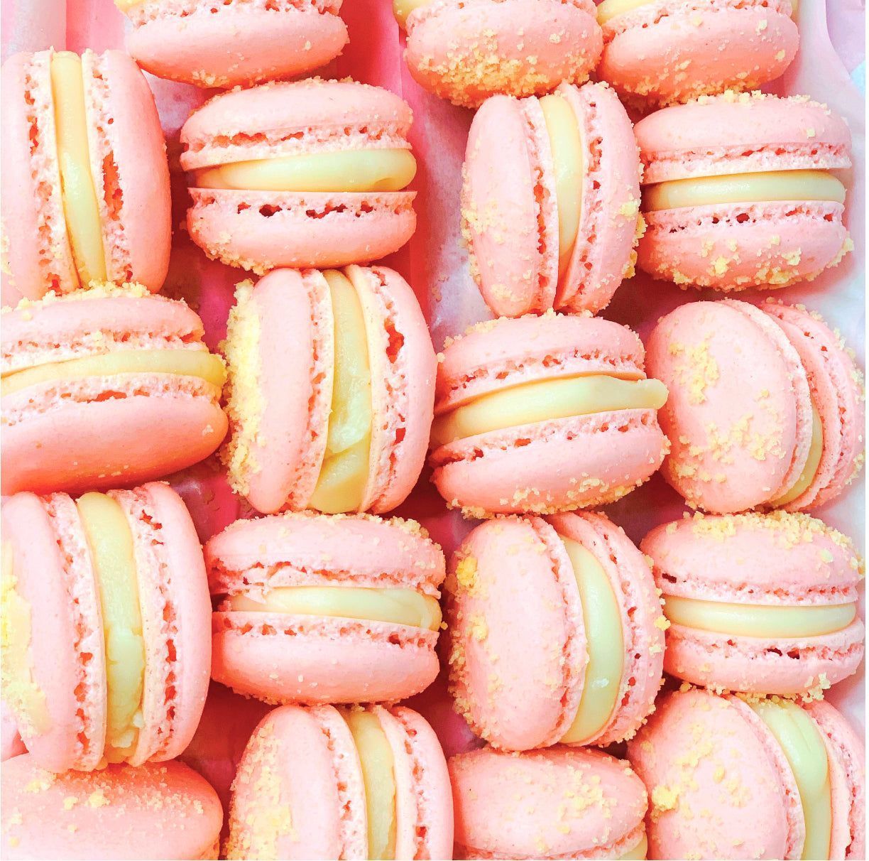 A box of pink and yellow macarons - Macarons