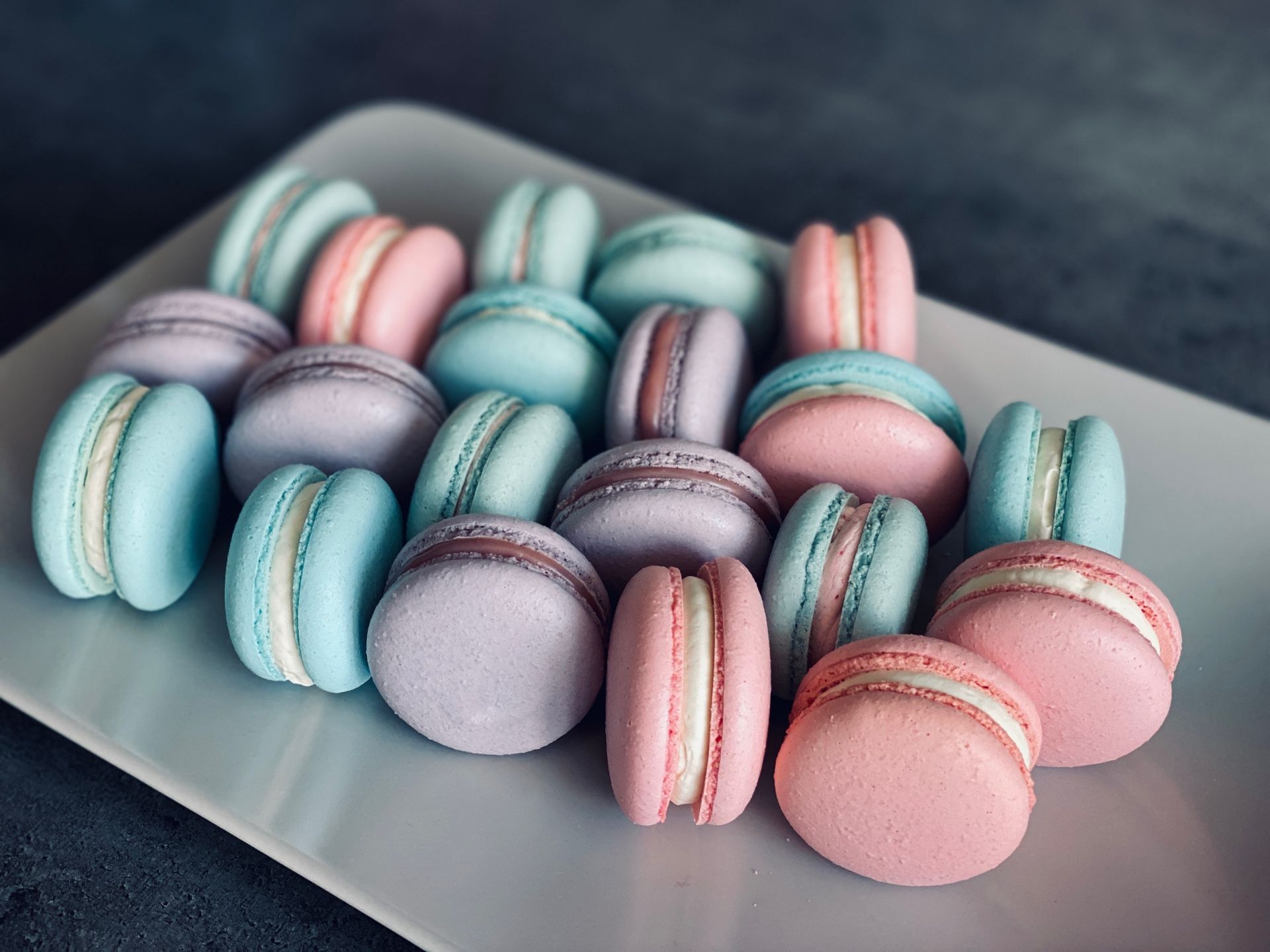 A plate of macarons in a variety of colors. - Macarons