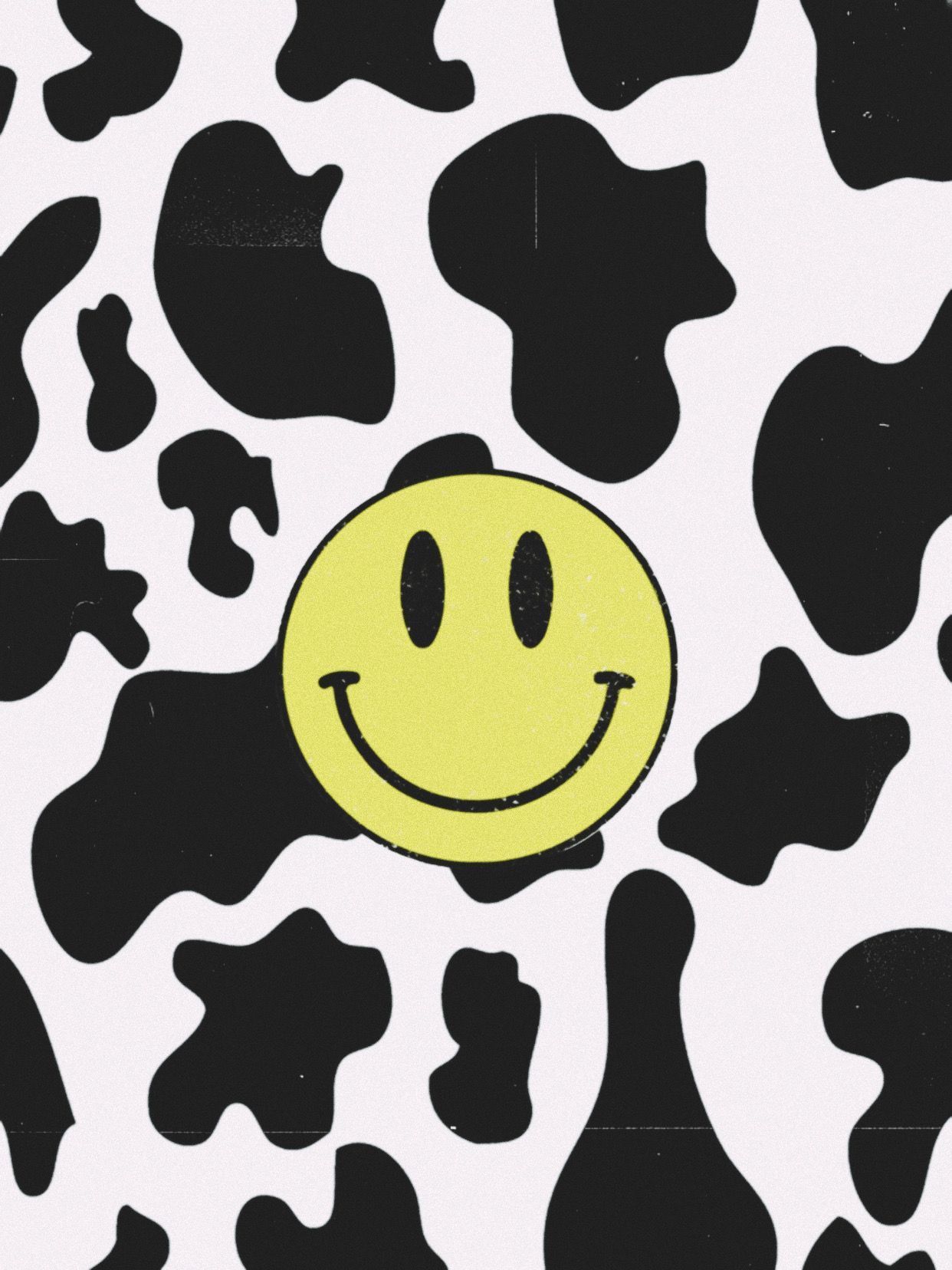 A smiling face on a cow print background - Smiley