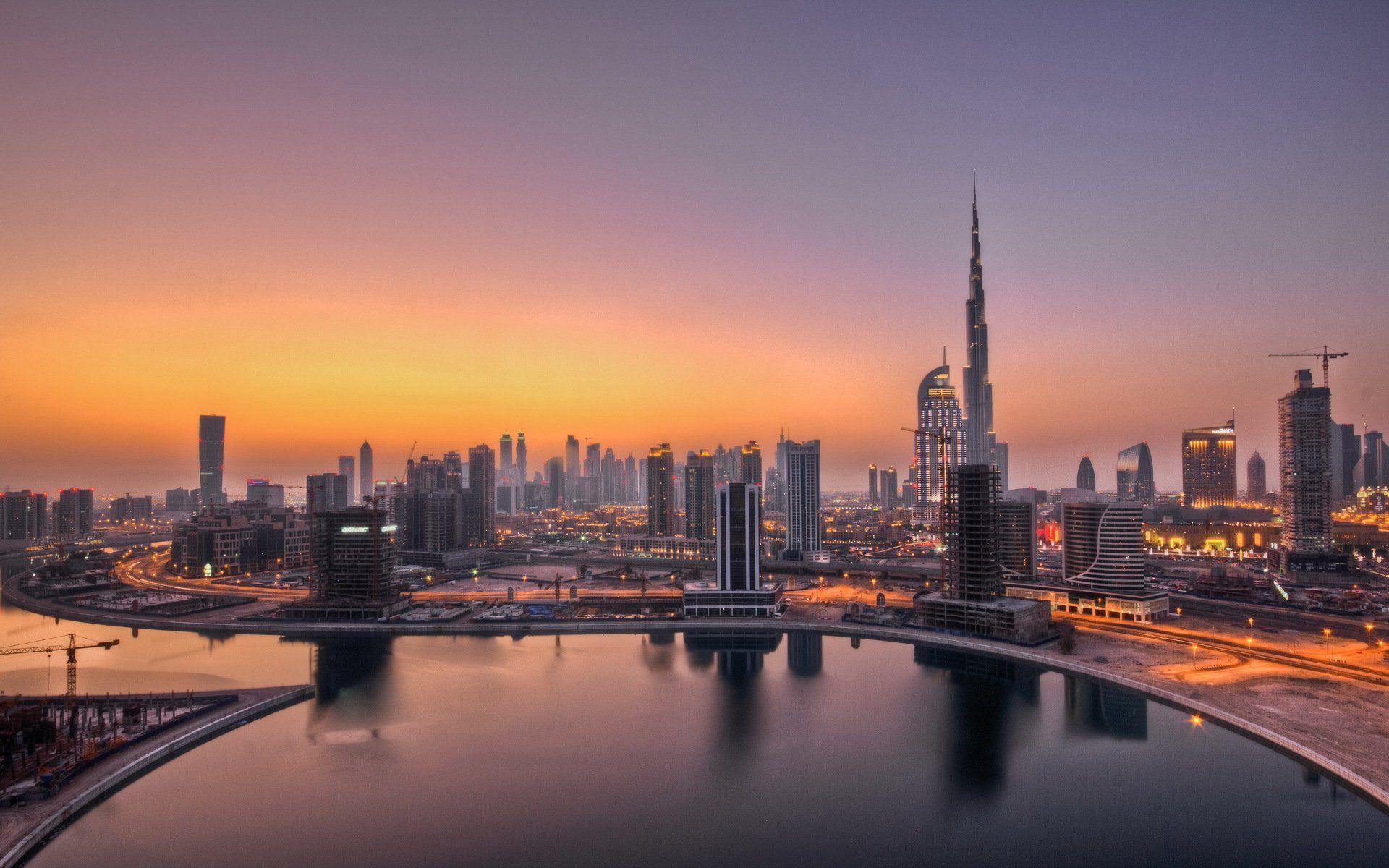 Dubai skyline at sunset with a pool in the foreground - Dubai