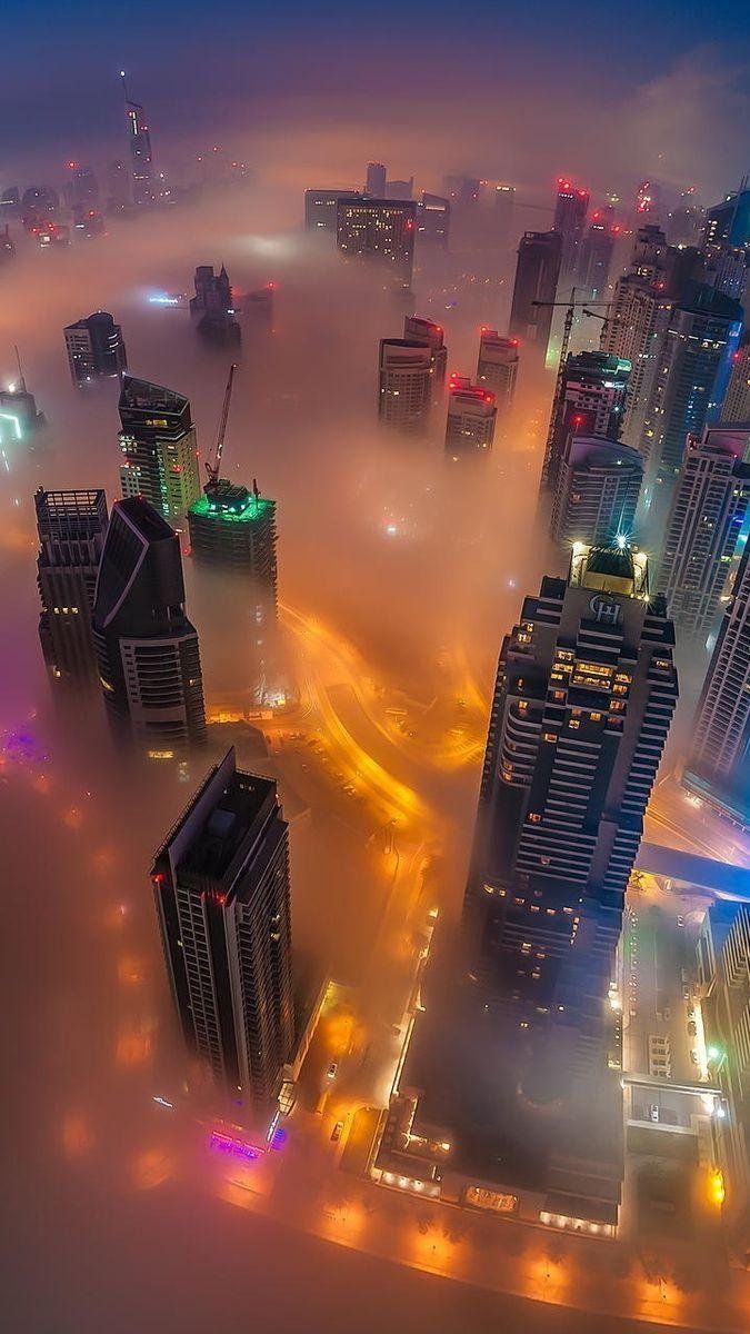 A cityscape is seen through the fog. - Dubai