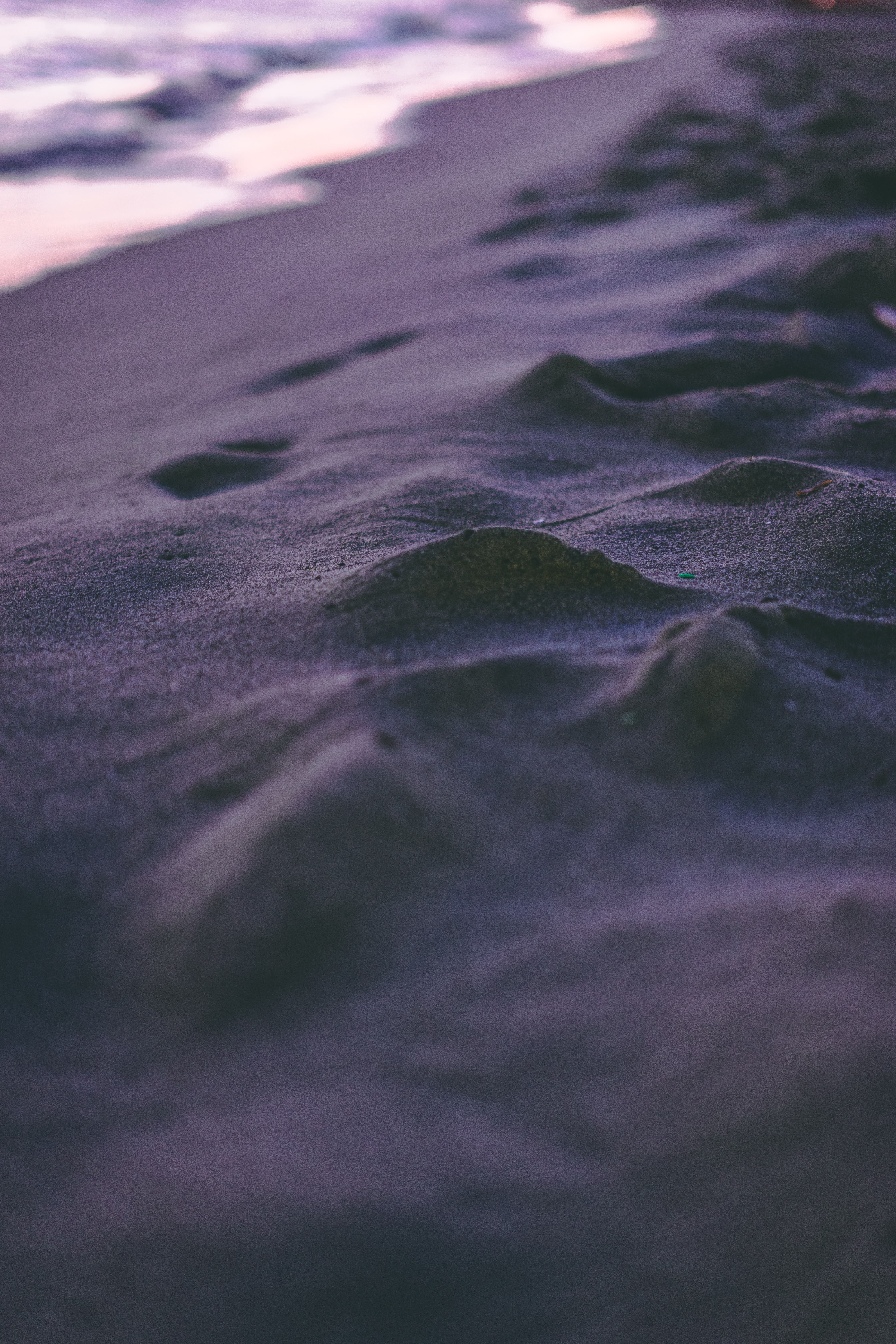 A close up of the sand and water at the beach - Coast, sand