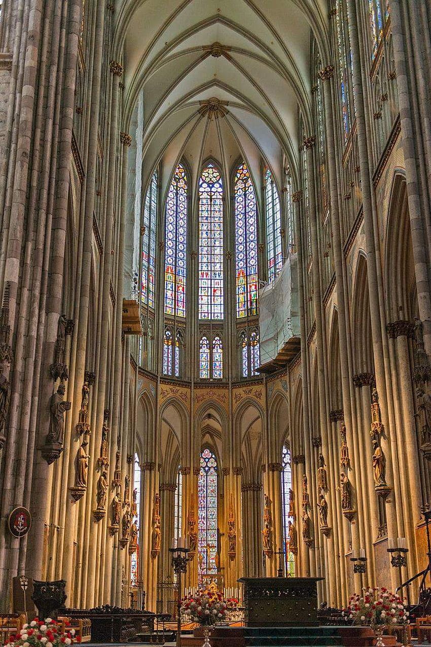 The interior of the Cologne Cathedral with its high vaulted ceiling and stained glass windows. - Architecture