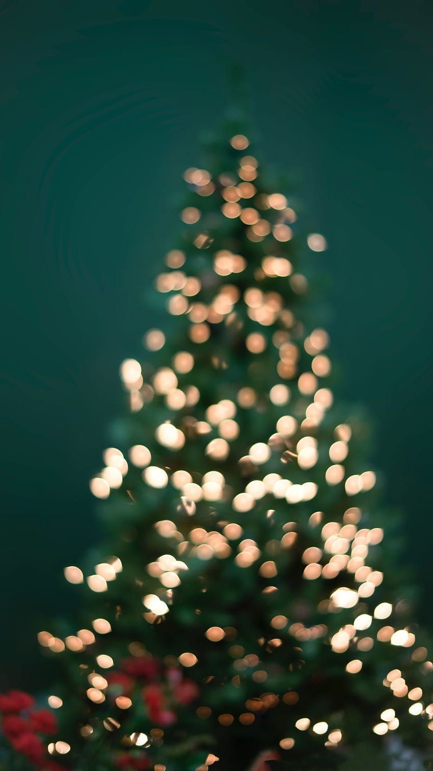 A blurred Christmas tree with white lights in the dark. - Christmas lights