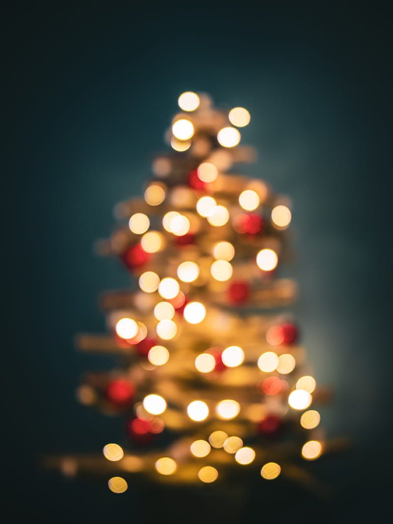 A blurry photo of a Christmas tree with red and white lights. - Christmas lights