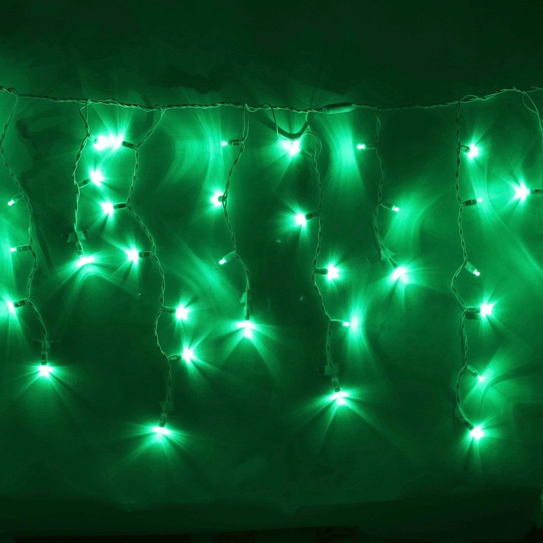 Green fairy lights hanging from a curtain - Christmas lights