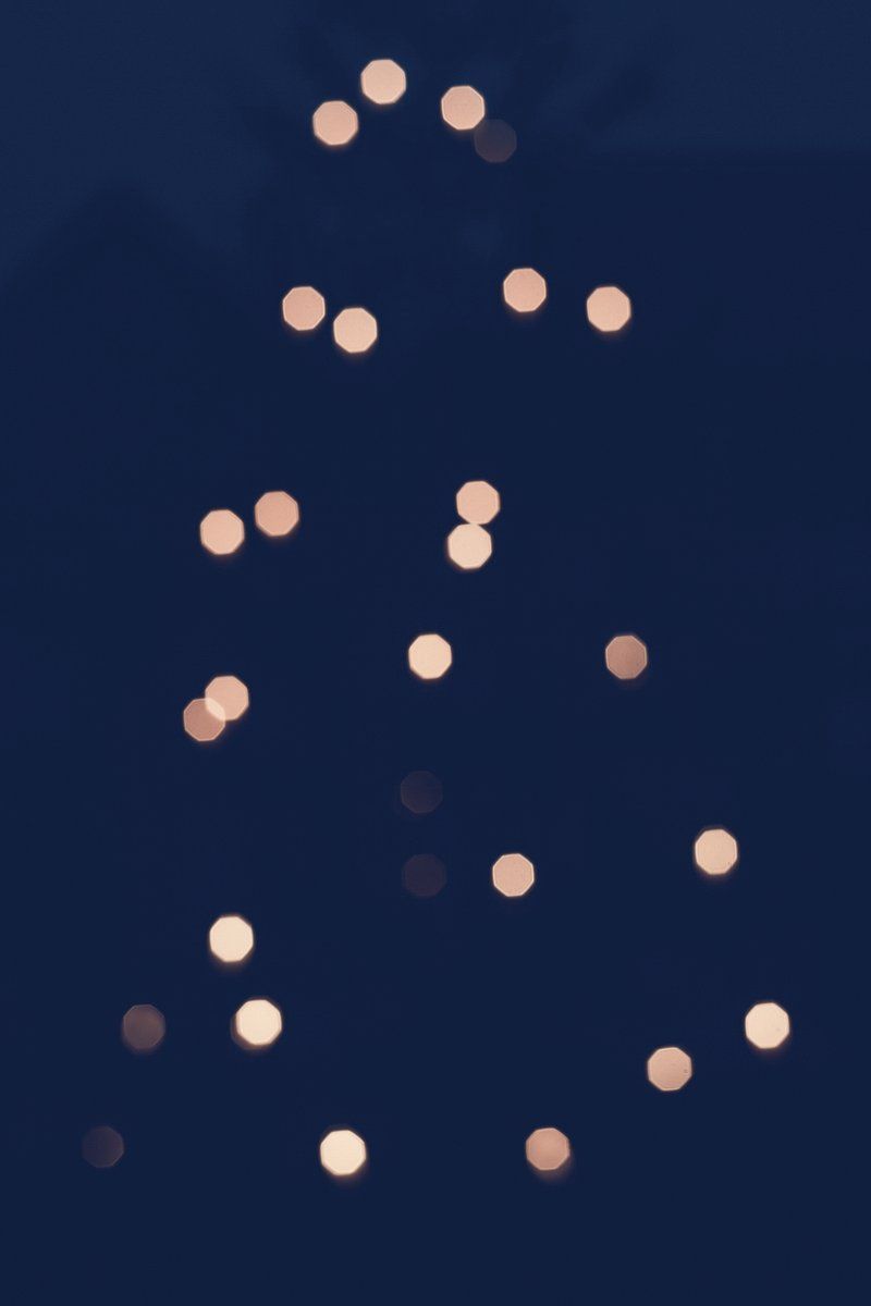 Golden bokeh lights on a dark blue background - Christmas lights