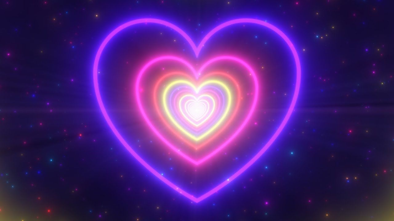 A purple and pink heart shaped light on the dark background - Heart