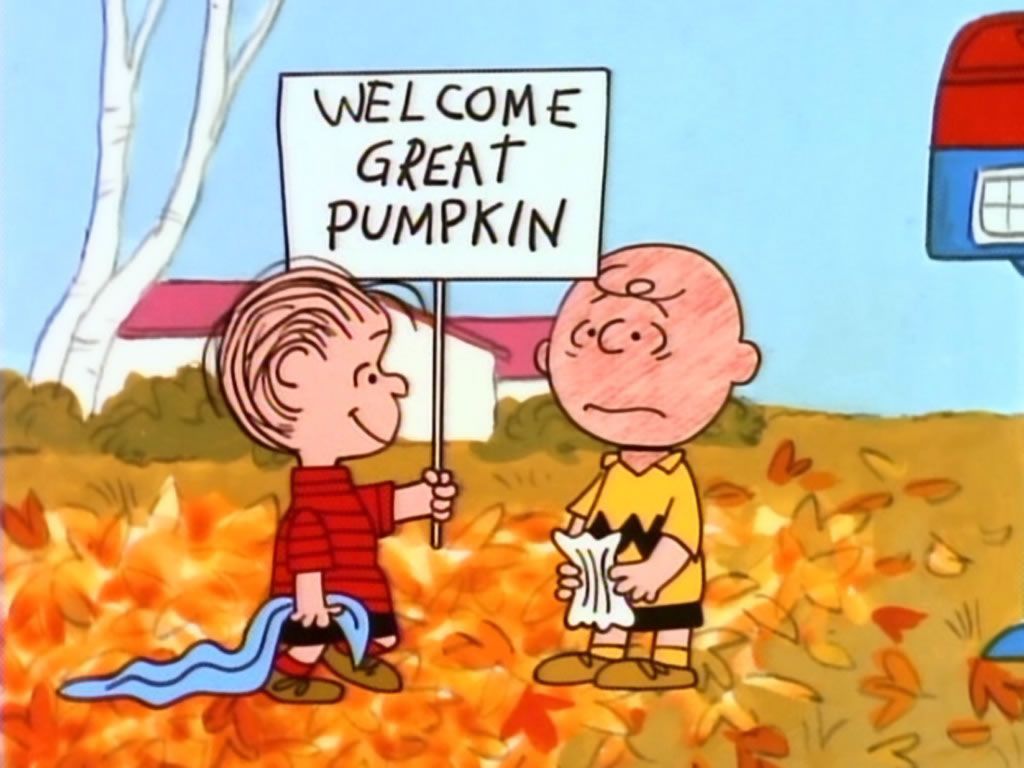 Charlie Brown and Linus in a pumpkin patch holding a sign that says 