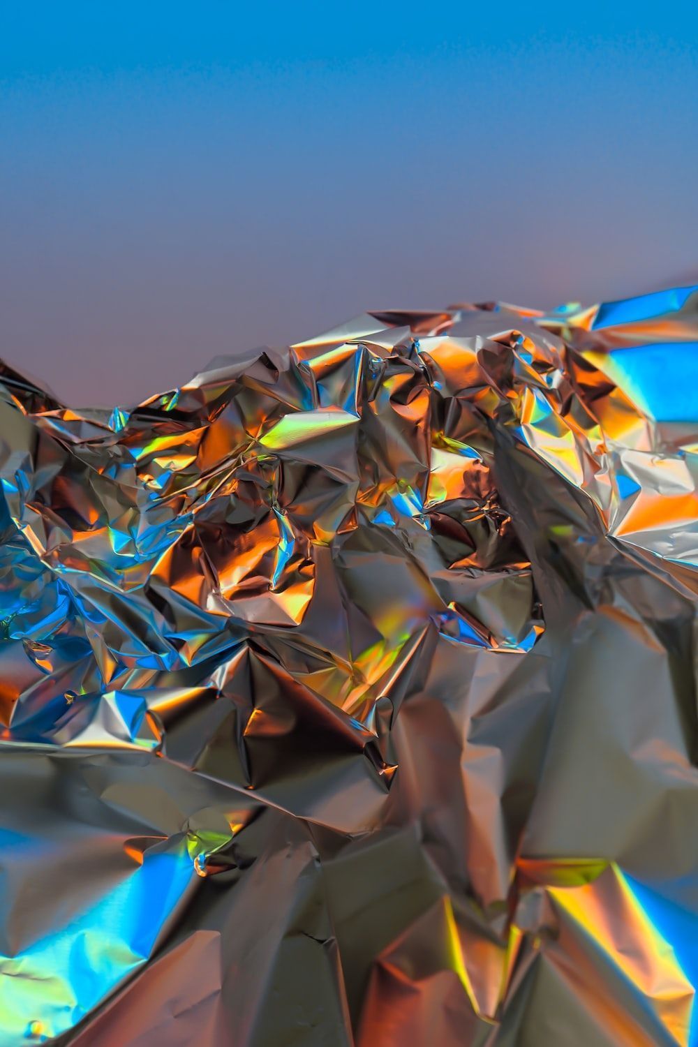 A crumpled piece of silver and rainbow foil - Silver, iridescent