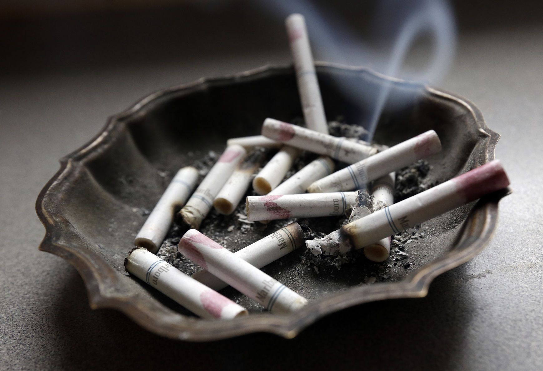 Cigarette butts in an ashtray - Smoke