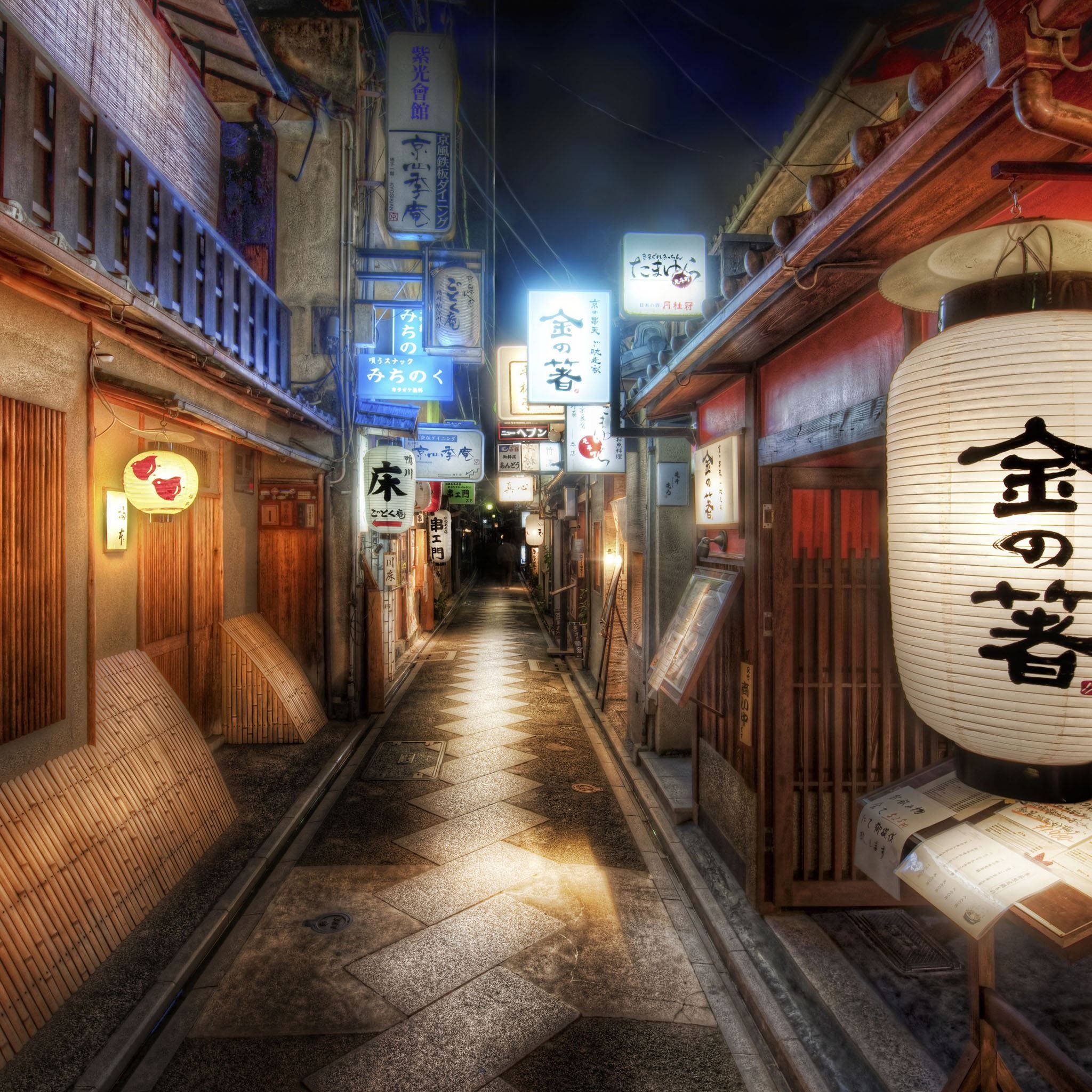 A narrow alleyway with lanterns and signs in Japanese. - Japan