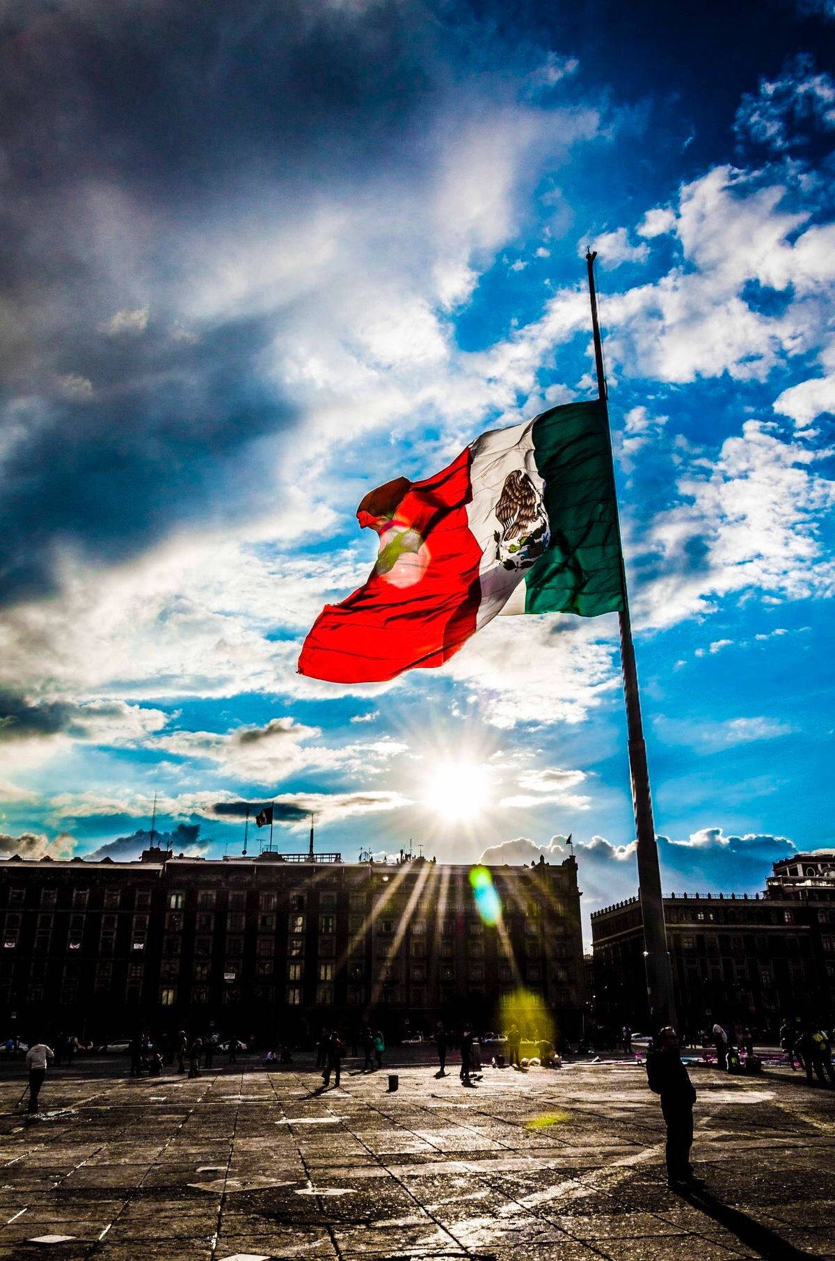 Download Vibrant Skies Above Mexico Flag Wallpaper