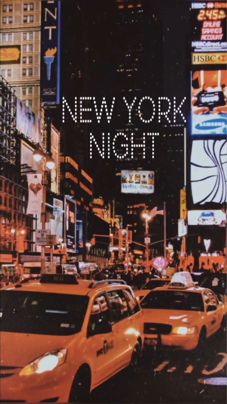 A New York night scene with taxis and neon lights. - New York