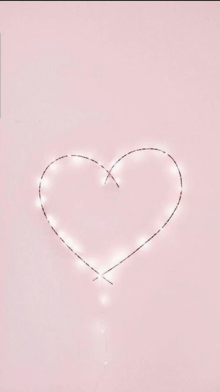 A heart outline made out of fairy lights on a pink background - Valentine's Day, lovecore