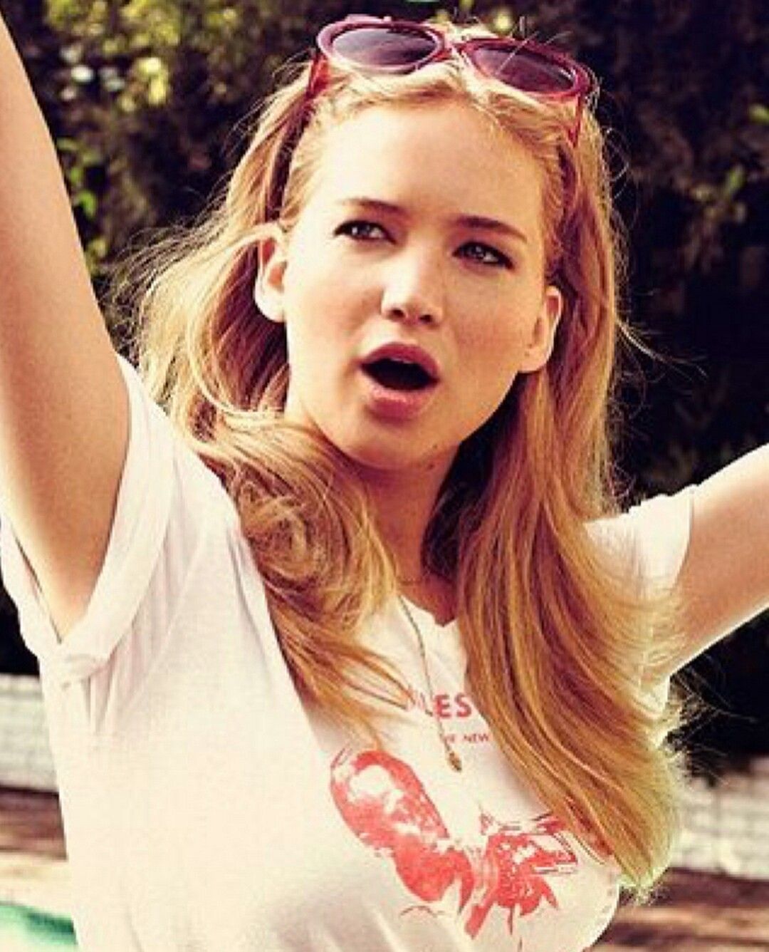 Jennifer Lawrence with her arms up and a surprised look on her face - Jennifer Lawrence