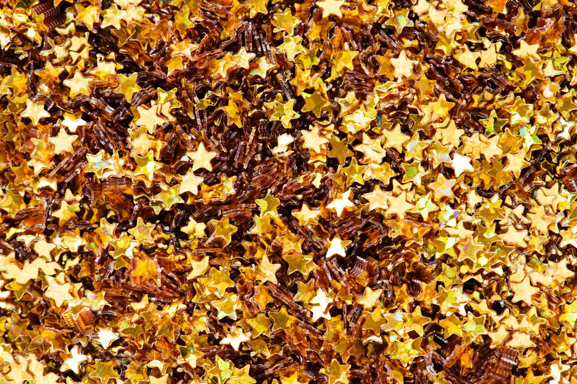 A close up of golden stars on a brown background - Gold
