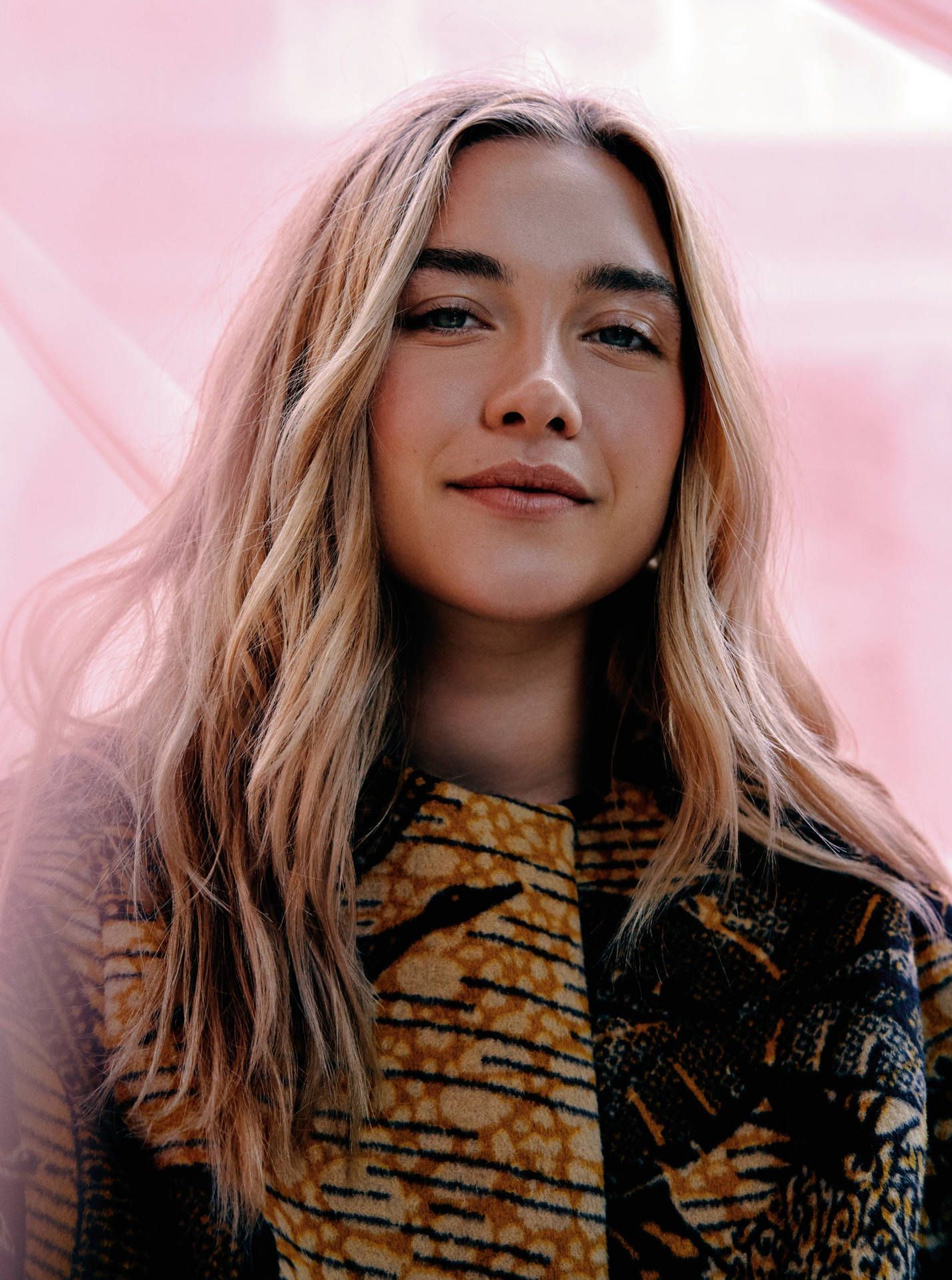 A woman with blonde hair and a coat with a tiger print. - Florence Pugh
