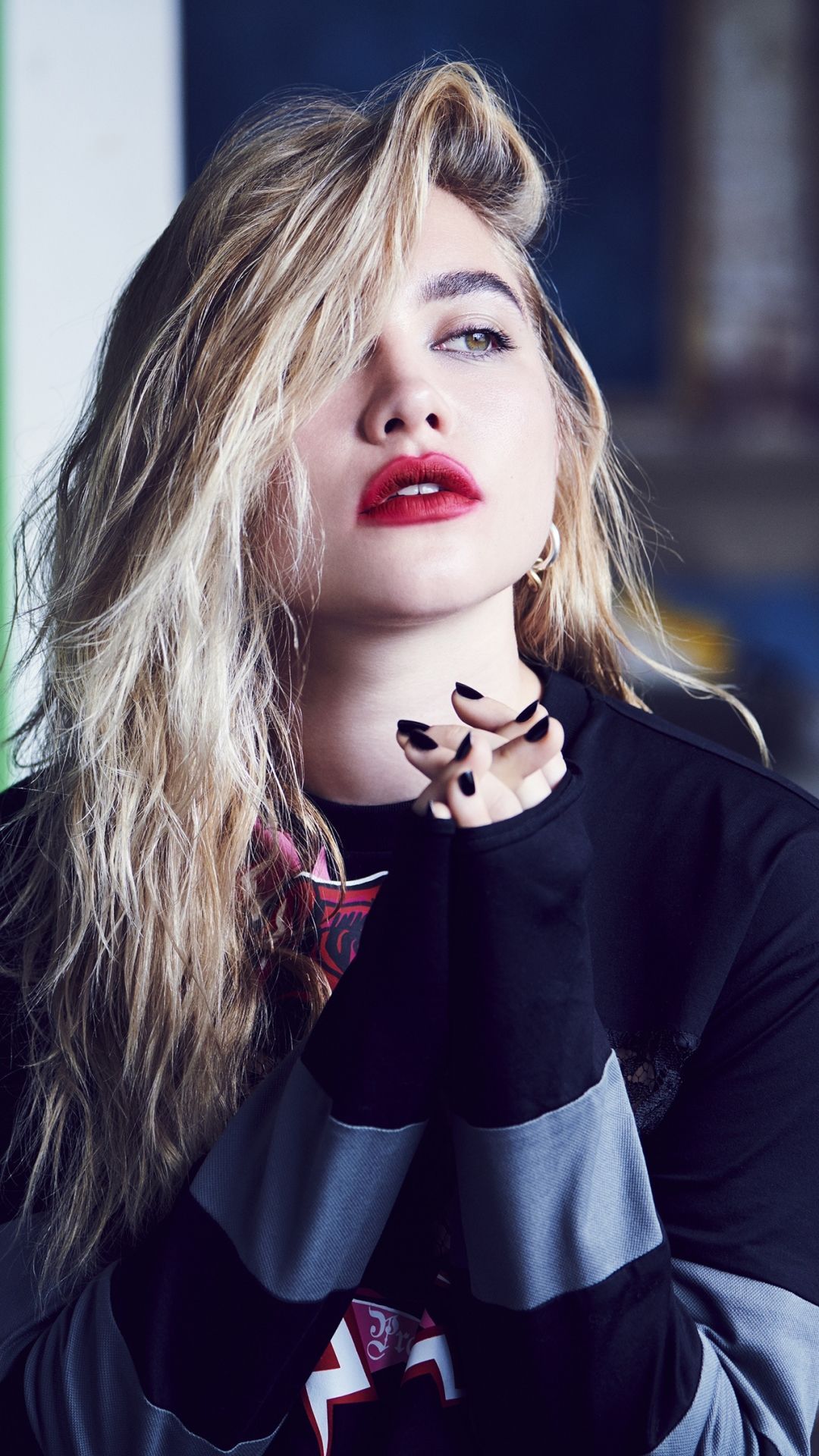 A woman with red lipstick and a black top. - Florence Pugh