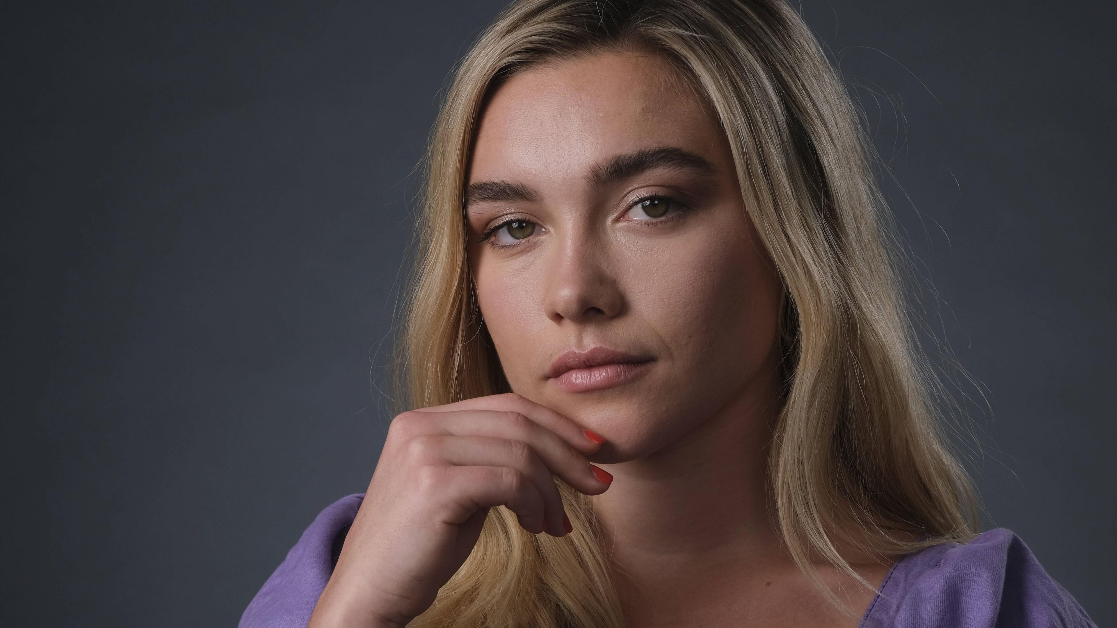 A woman with her hand under her chin - Florence Pugh