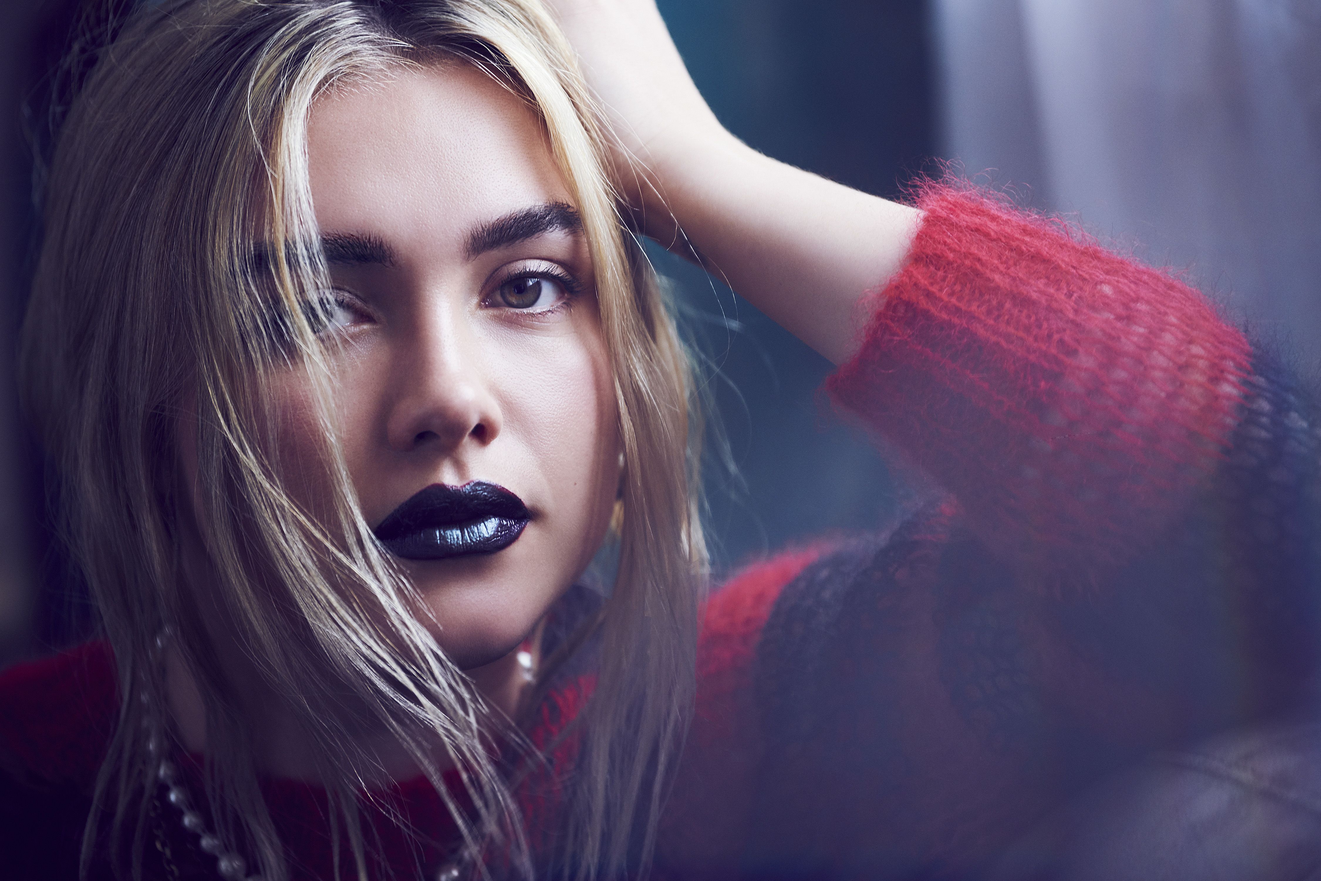 A woman with black lipstick and a red sweater - Florence Pugh