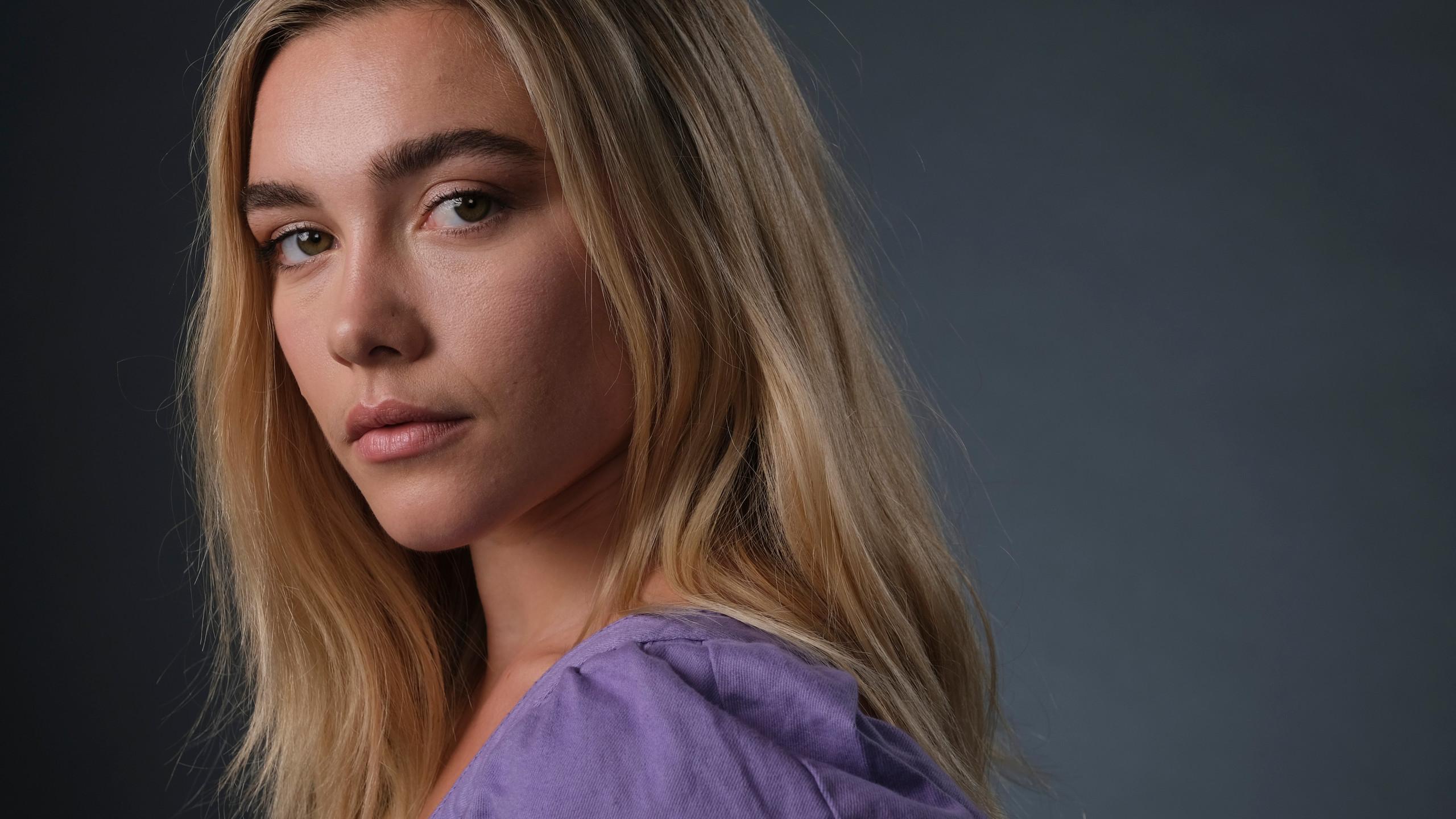 A woman with blonde hair and a purple shirt - Florence Pugh