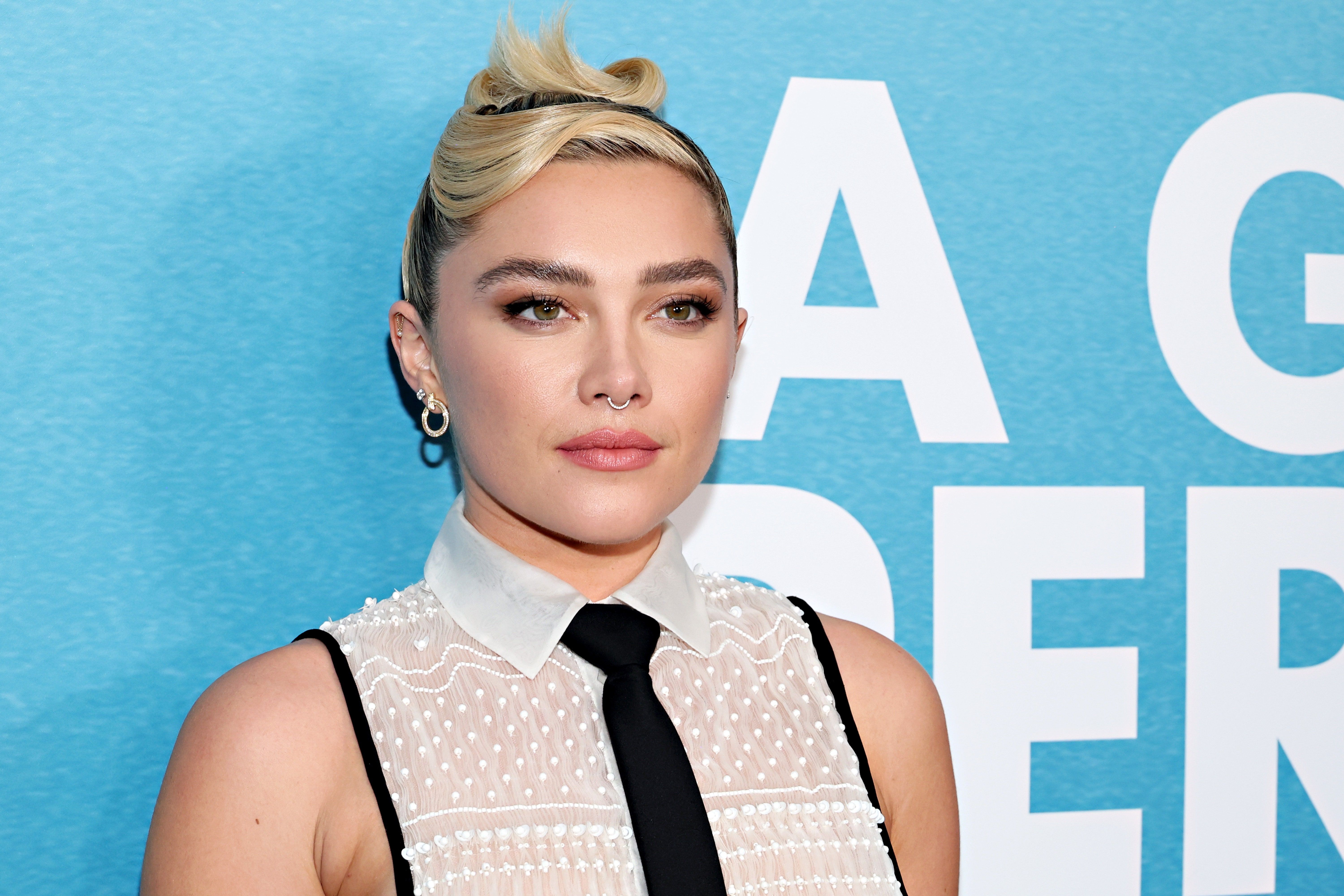 Florence Pugh put a twist on the classic shirt and tie combo for the red carpet. - Florence Pugh
