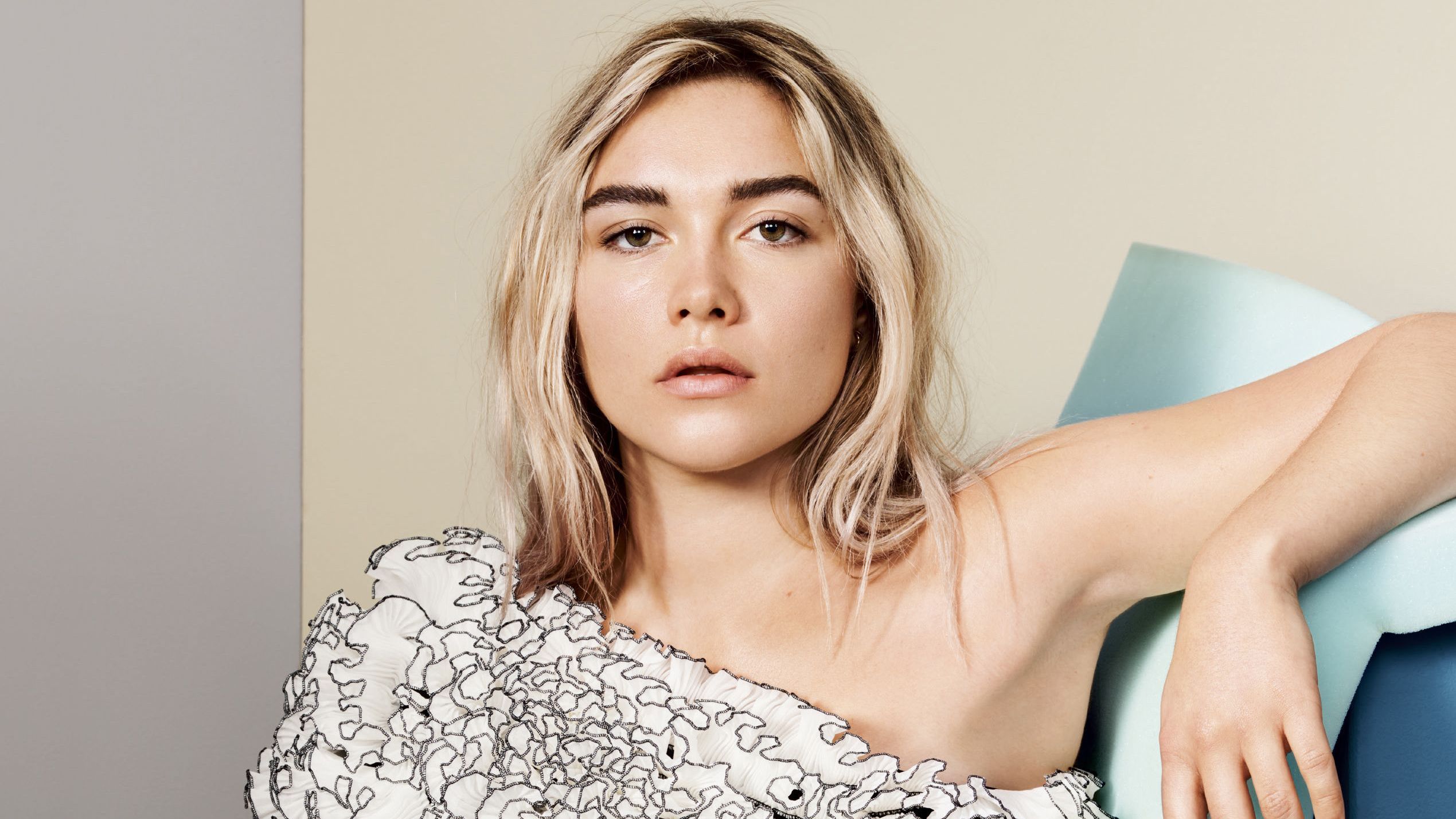 Florence Pugh leaning on a blue chair - Florence Pugh