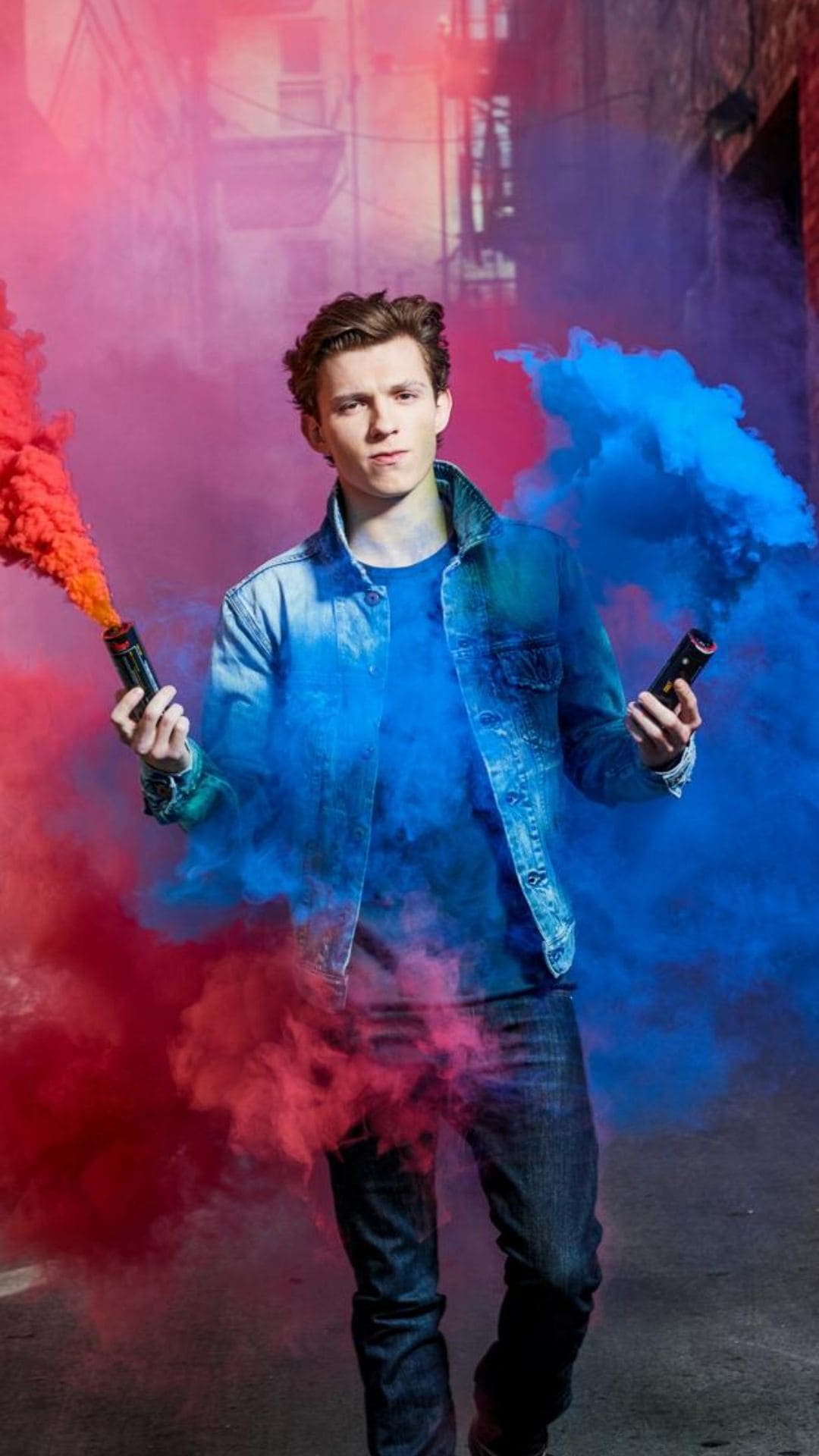 Tom Holland holding smoke bombs in his hands - Tom Holland