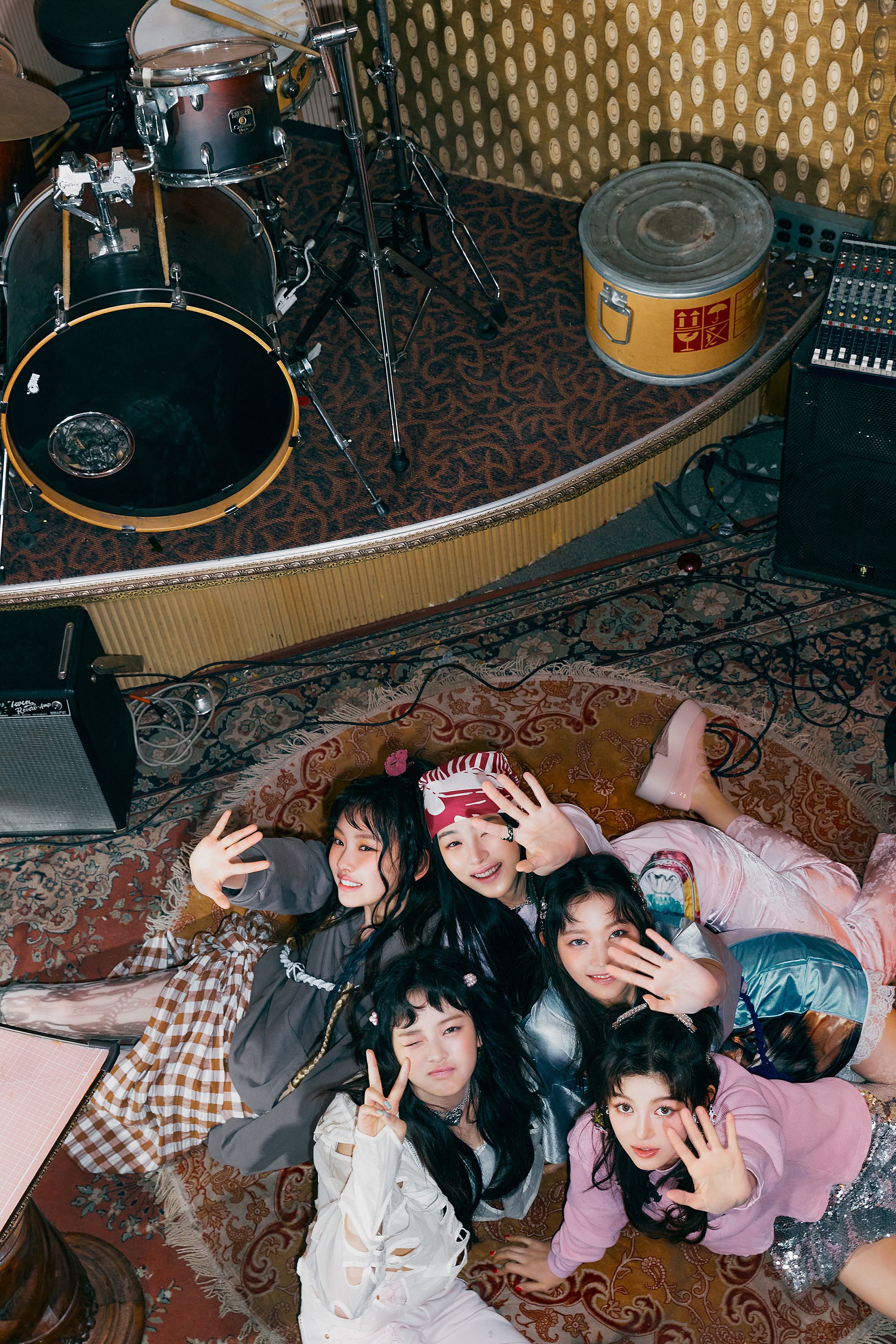 The members of SORbet pose for a photo on a carpet in a recording studio. - NewJeans