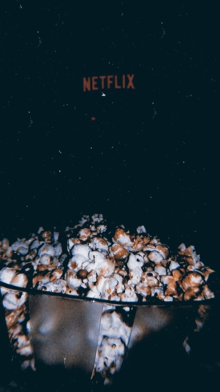 A bowl of popcorn in front of a Netflix logo. - Popcorn