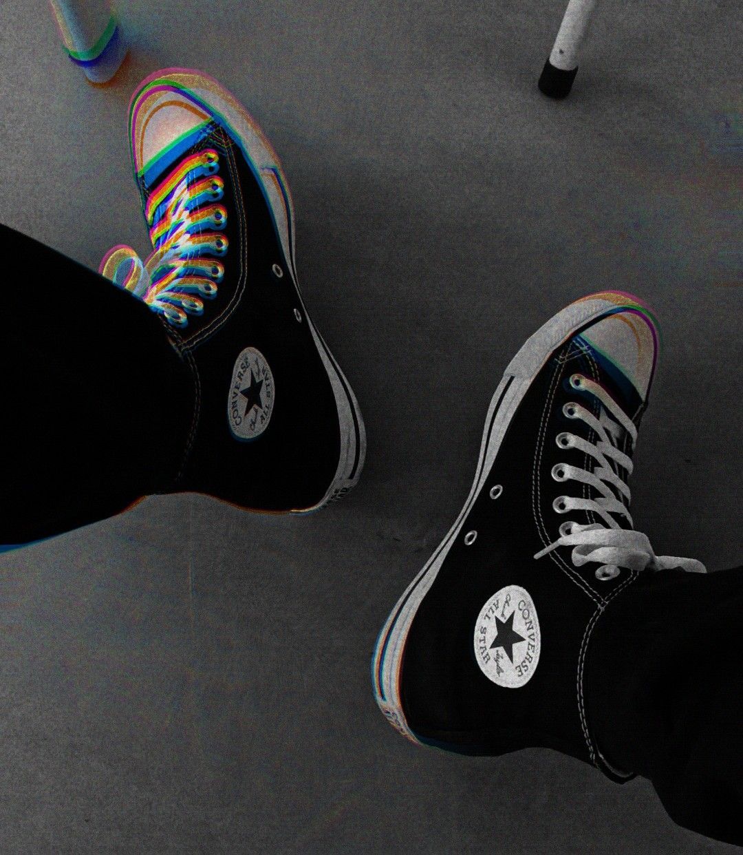 Two converse shoes, one with rainbow laces and the other with black laces - Converse