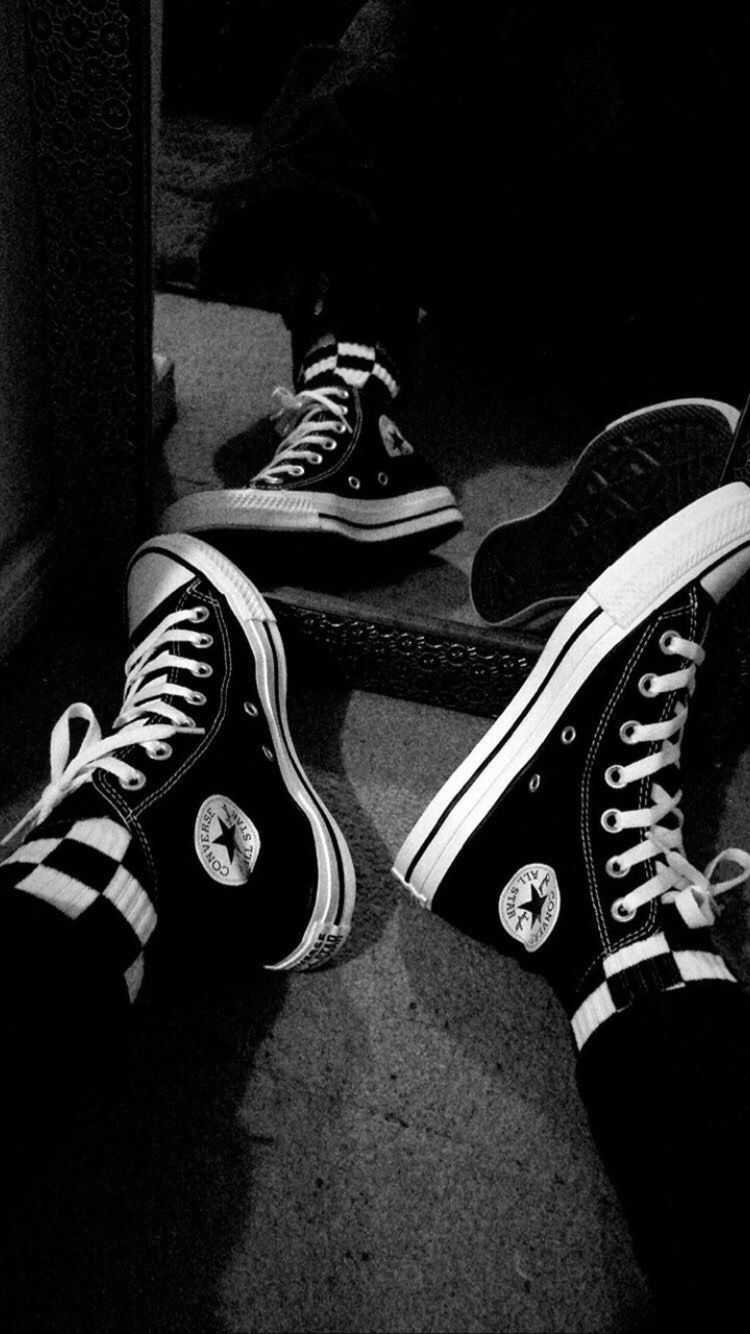 A pair of black and white converse shoes - Converse