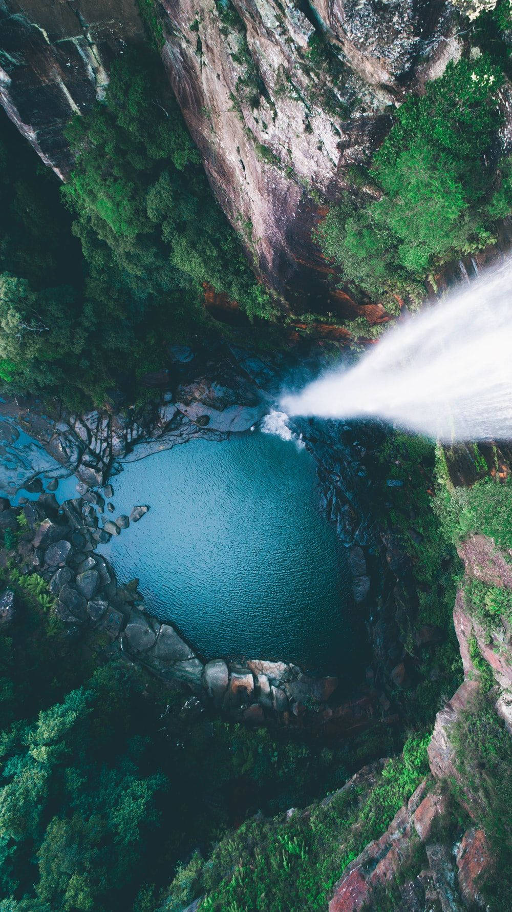 Aerial view of a waterfall in a green forest. - Waterfall